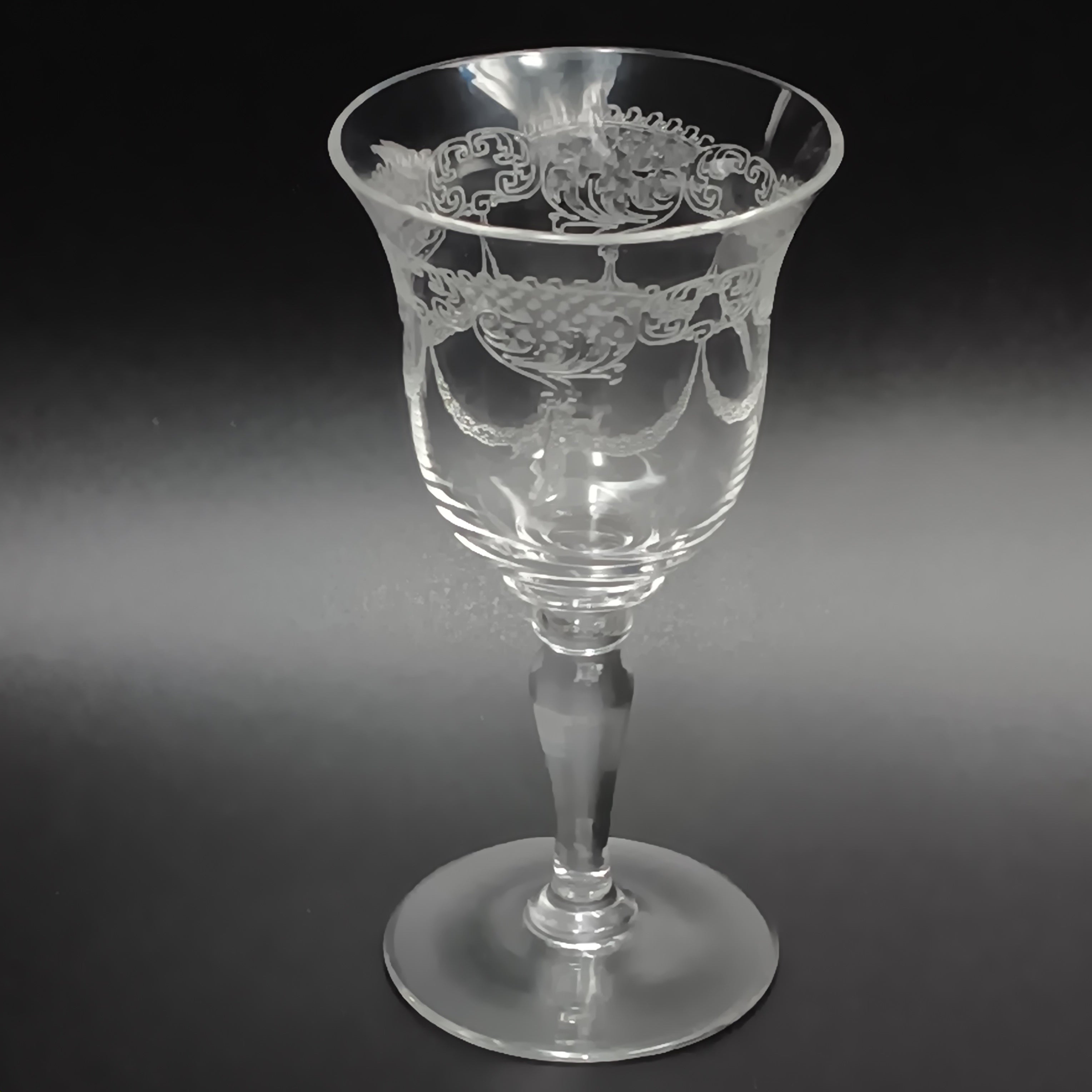Clear 4½-inch etched crystal wine glass with ornate floral and crown-like patterns on the bowl, faceted stem, and wide flat base