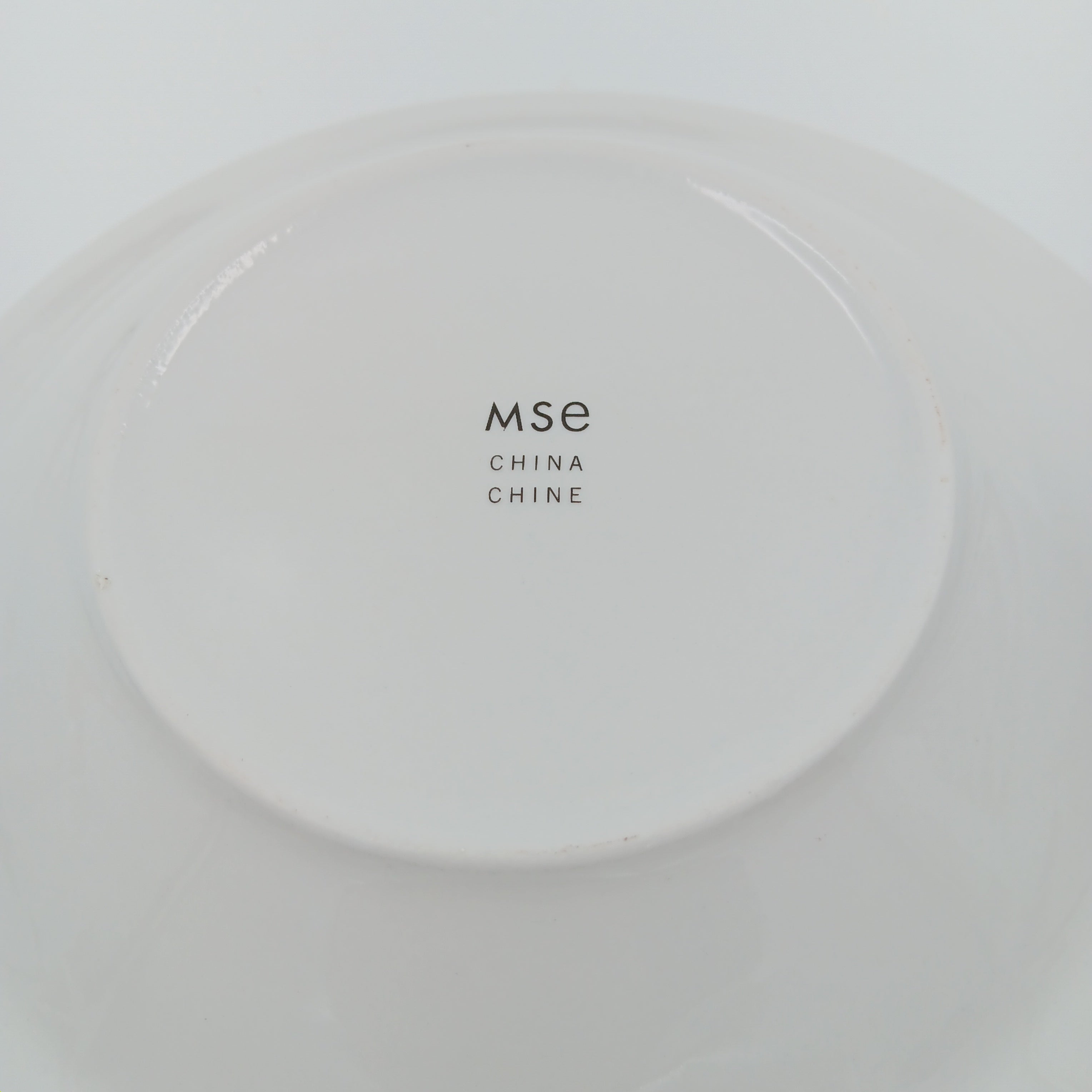 Elegant white porcelain dinner plate with gold trim from luxury china set