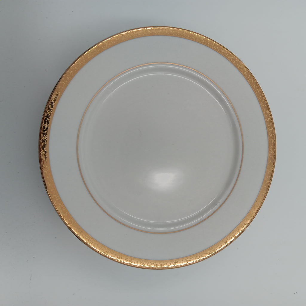 Elegant white porcelain dinner plate with gold trim from luxury china set