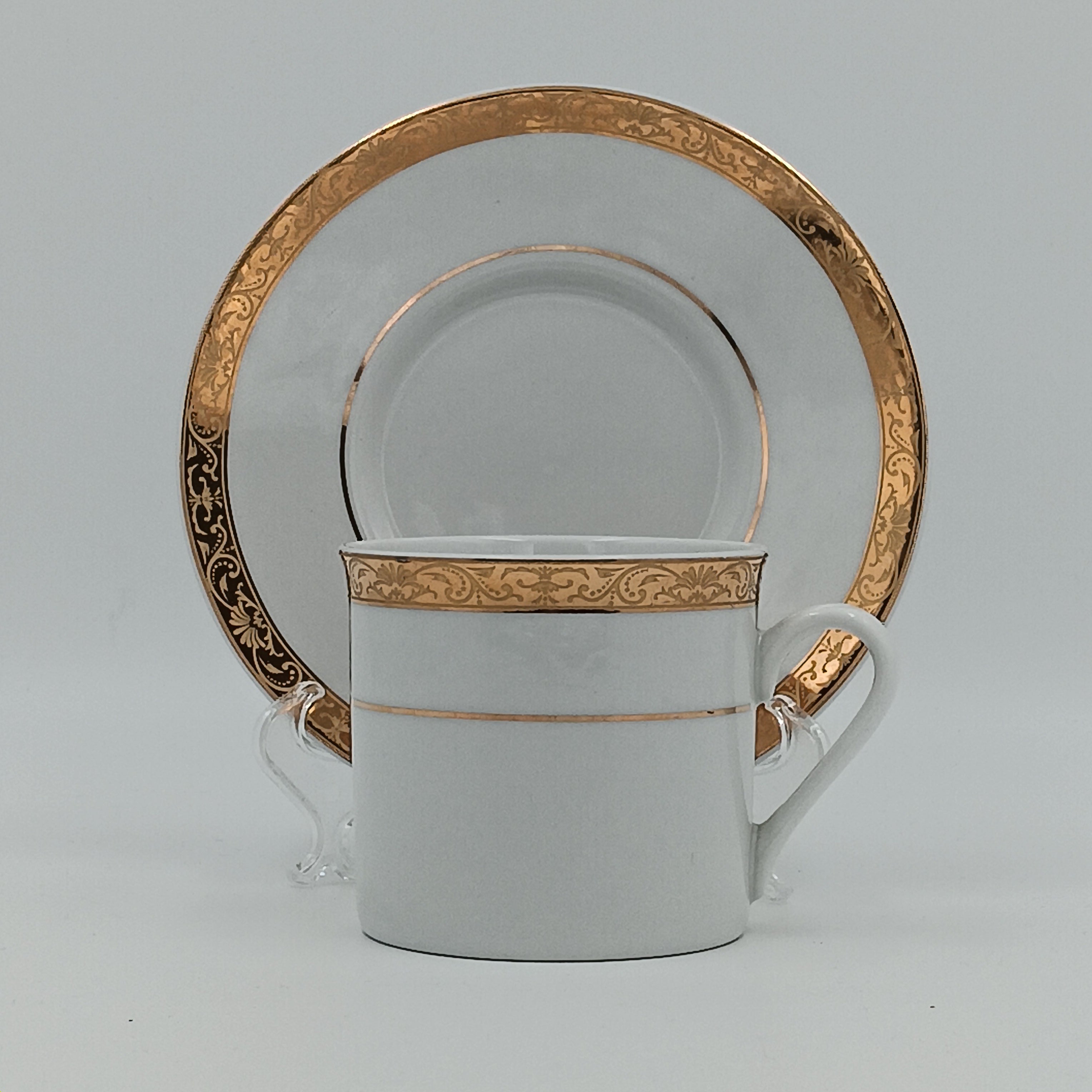 White porcelain teacup and saucer with gold detailing, part of 30-piece china set