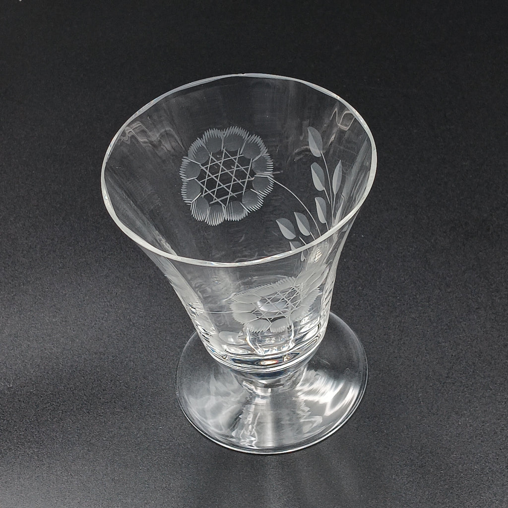 Clear glass W.J. Hughes Cornflower footed tumbler with etched floral design, wide rim tapering to a flared circular base