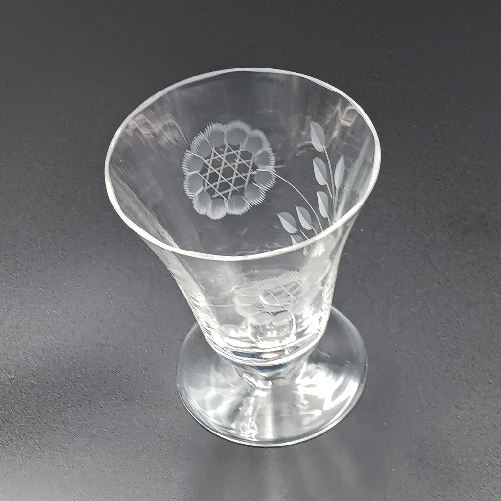Clear glass W.J. Hughes Cornflower footed tumbler with etched floral design, wide rim tapering to a flared circular base