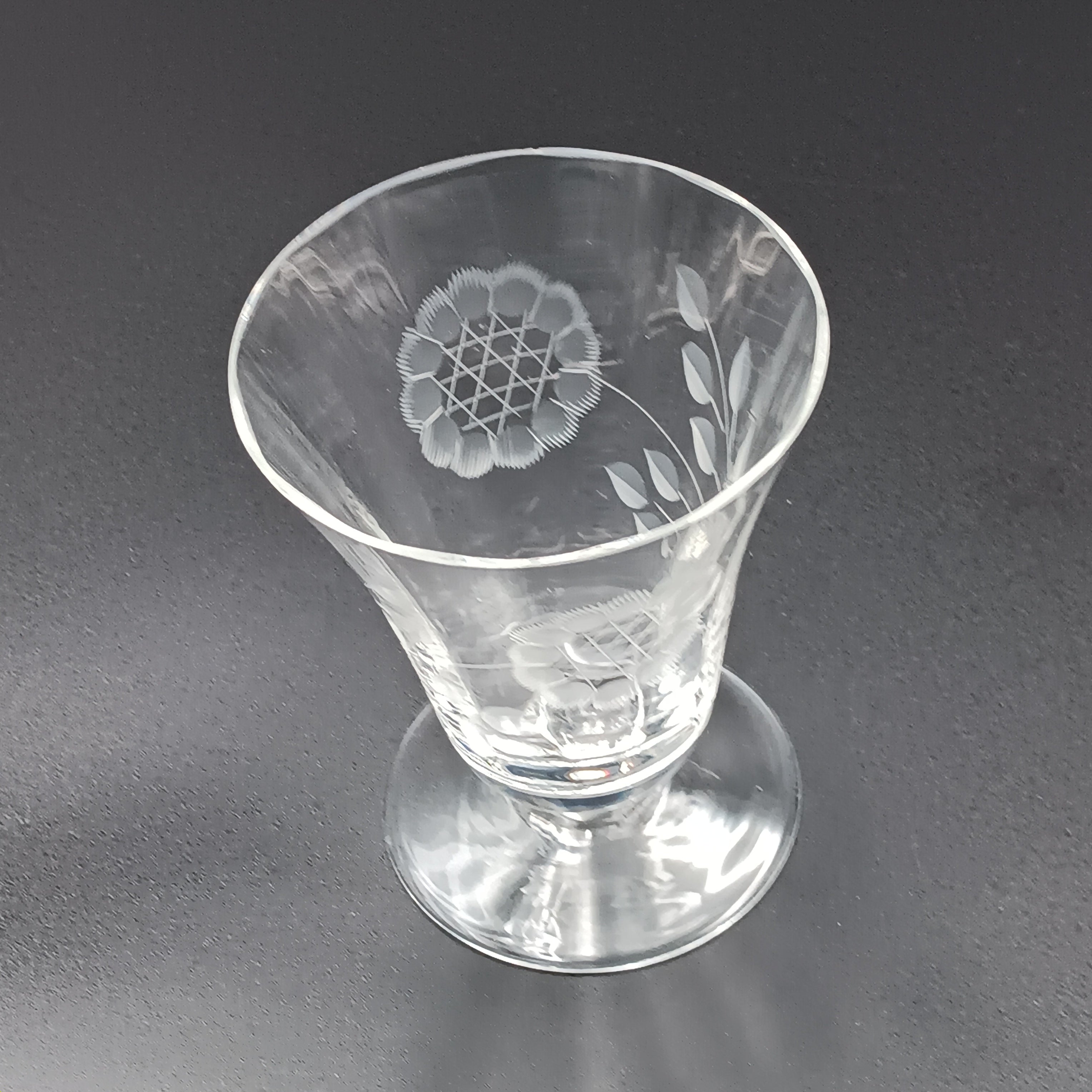 Clear glass W.J. Hughes Cornflower footed tumbler with etched floral design, wide rim tapering to a flared circular base