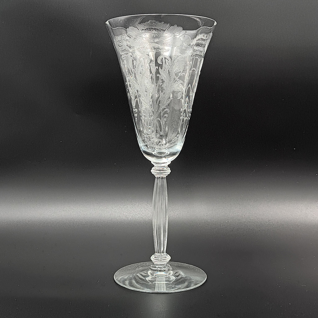Vintage Tiffin-Franciscan 'Flanders Clear' 8¼ inch water goblet featuring intricate floral etching on the bowl, a ribbed stem, and a flat circular base.