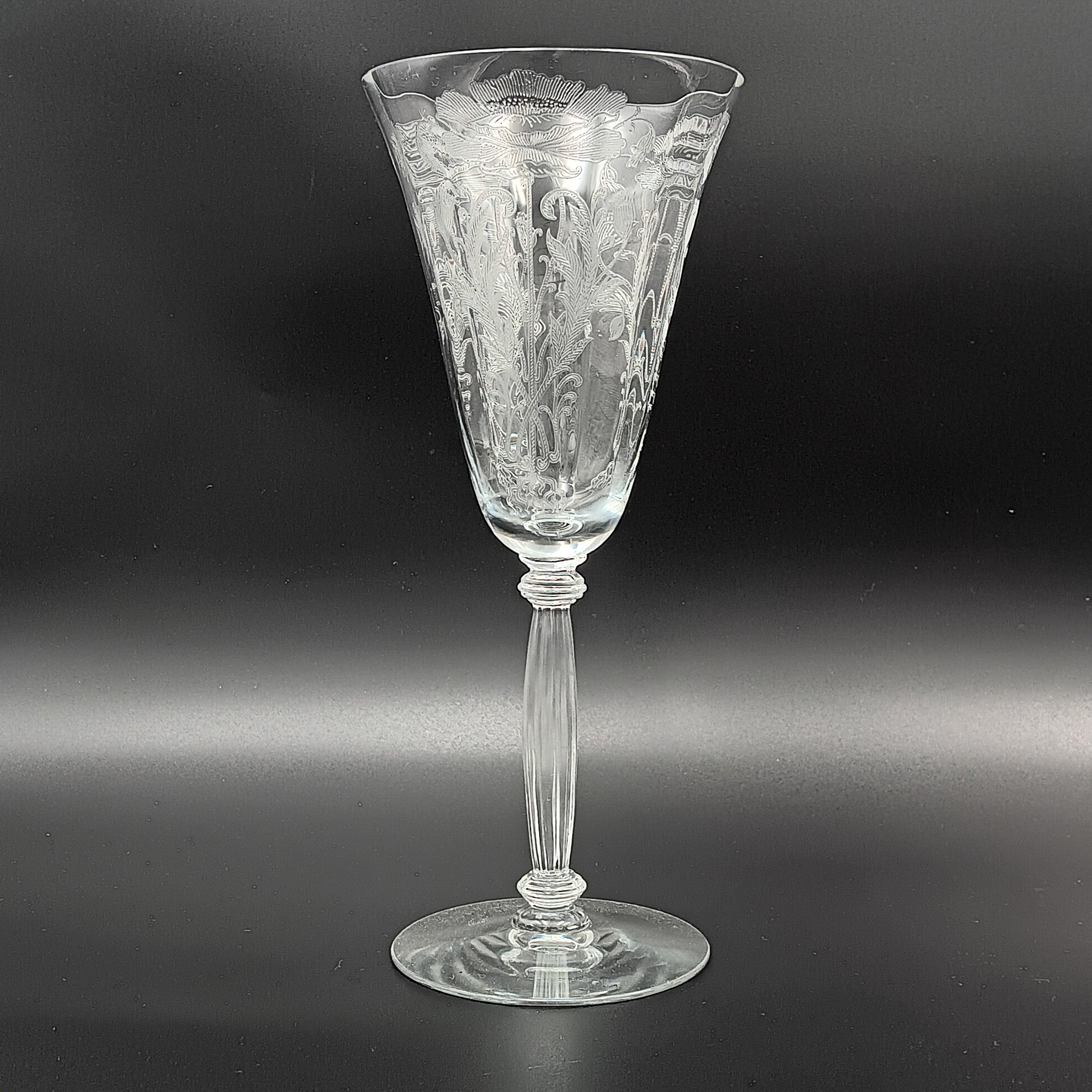 Vintage Tiffin-Franciscan 'Flanders Clear' 8¼ inch water goblet featuring intricate floral etching on the bowl, a ribbed stem, and a flat circular base.