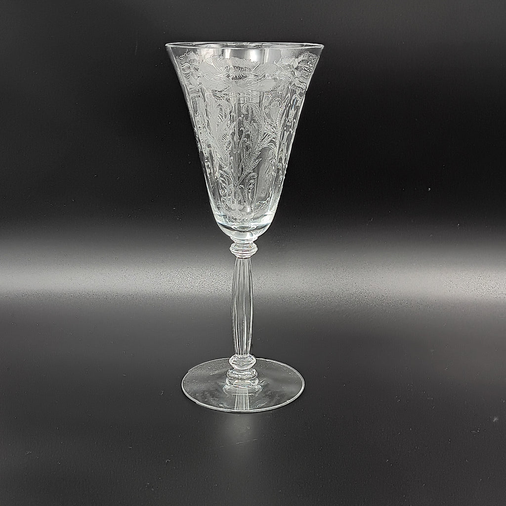 Vintage Tiffin-Franciscan 'Flanders Clear' 8¼ inch water goblet featuring intricate floral etching on the bowl, a ribbed stem, and a flat circular base.