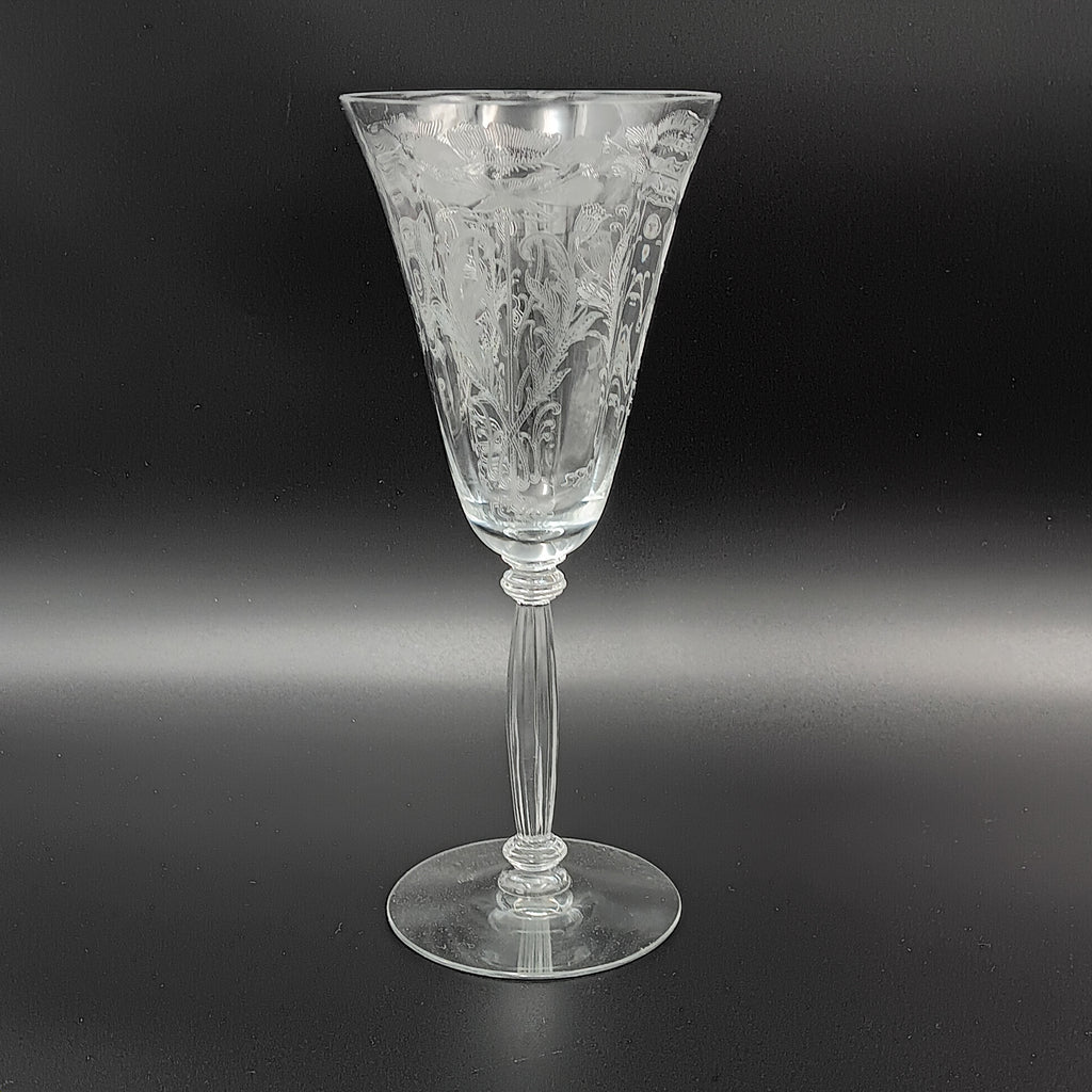 Vintage Tiffin-Franciscan 'Flanders Clear' 8¼ inch water goblet featuring intricate floral etching on the bowl, a ribbed stem, and a flat circular base.