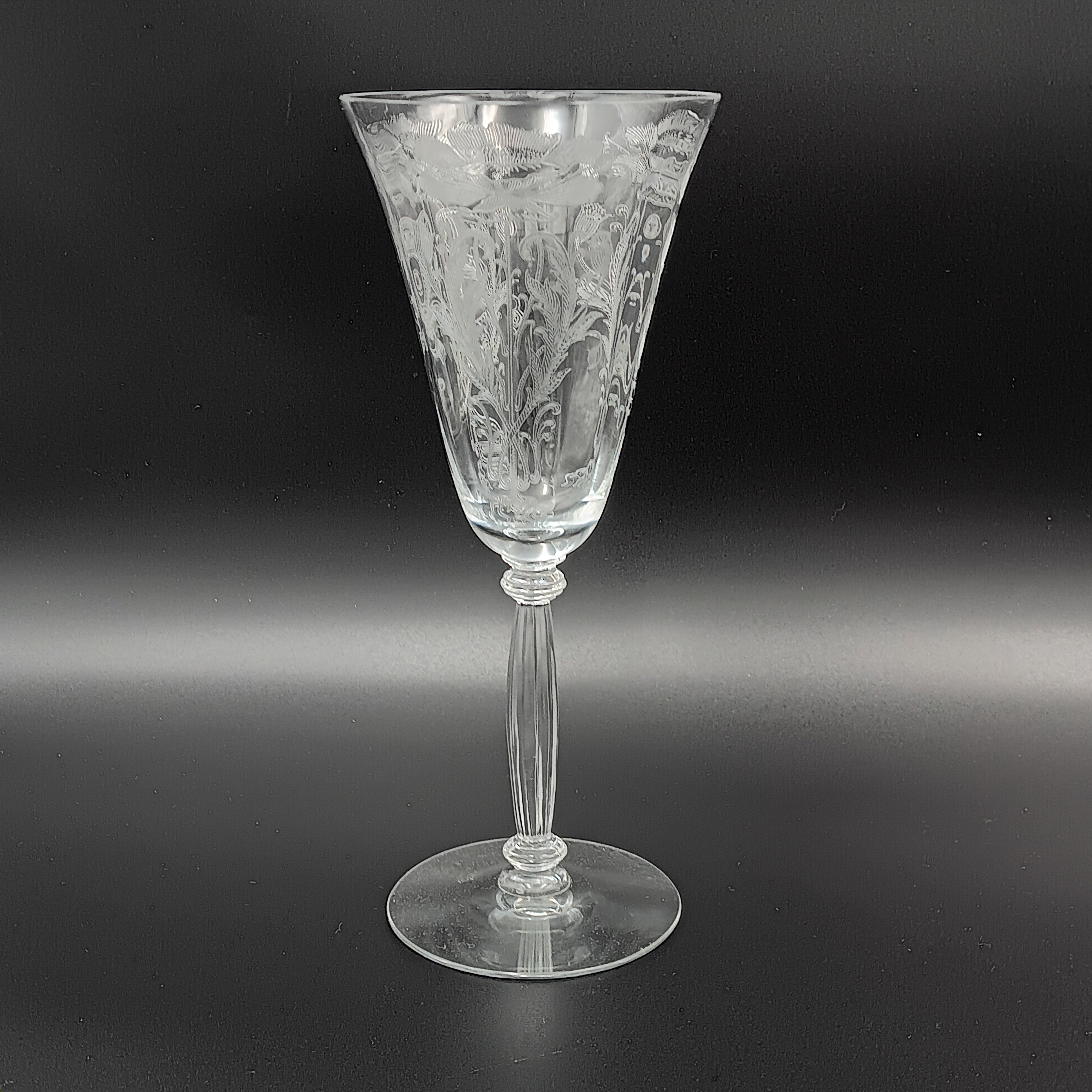 Vintage Tiffin-Franciscan 'Flanders Clear' 8¼ inch water goblet featuring intricate floral etching on the bowl, a ribbed stem, and a flat circular base.