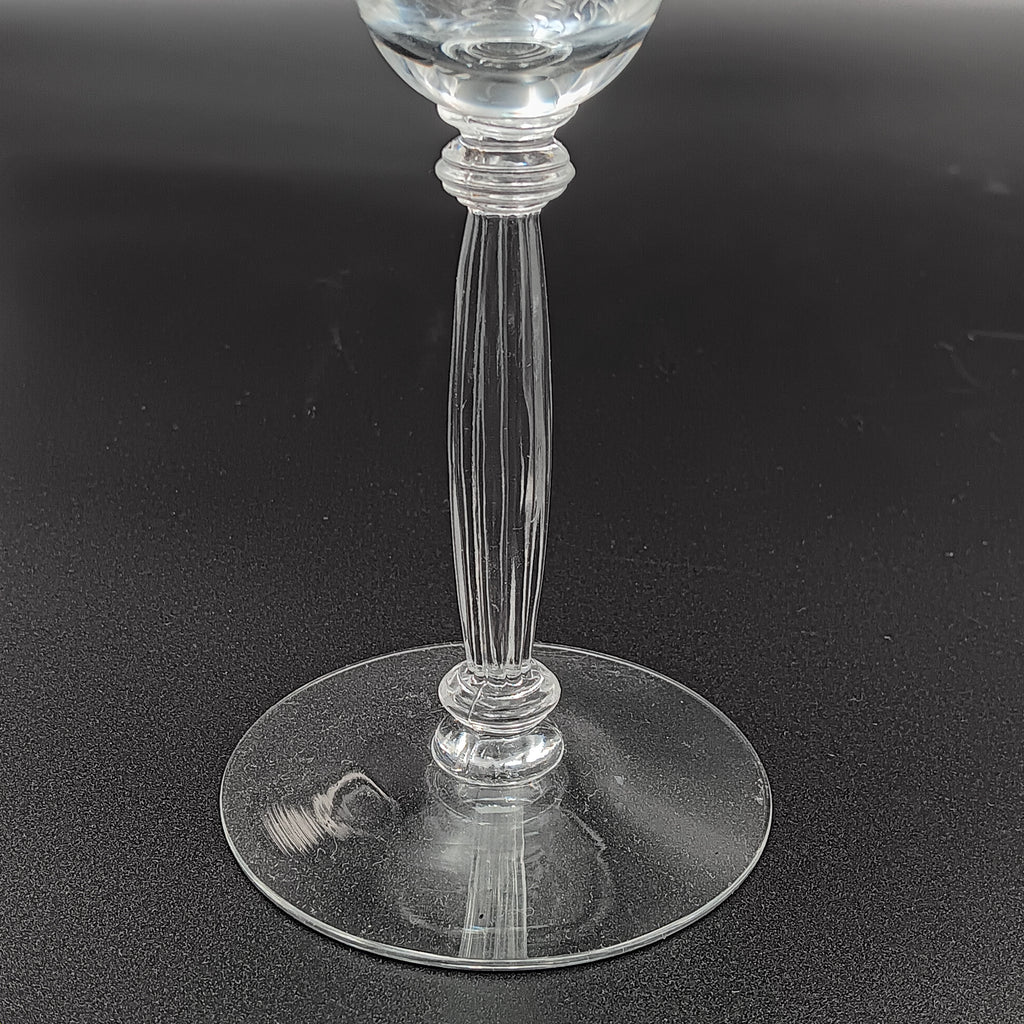Vintage Tiffin-Franciscan 'Flanders Clear' 8¼ inch water goblet featuring intricate floral etching on the bowl, a ribbed stem, and a flat circular base.