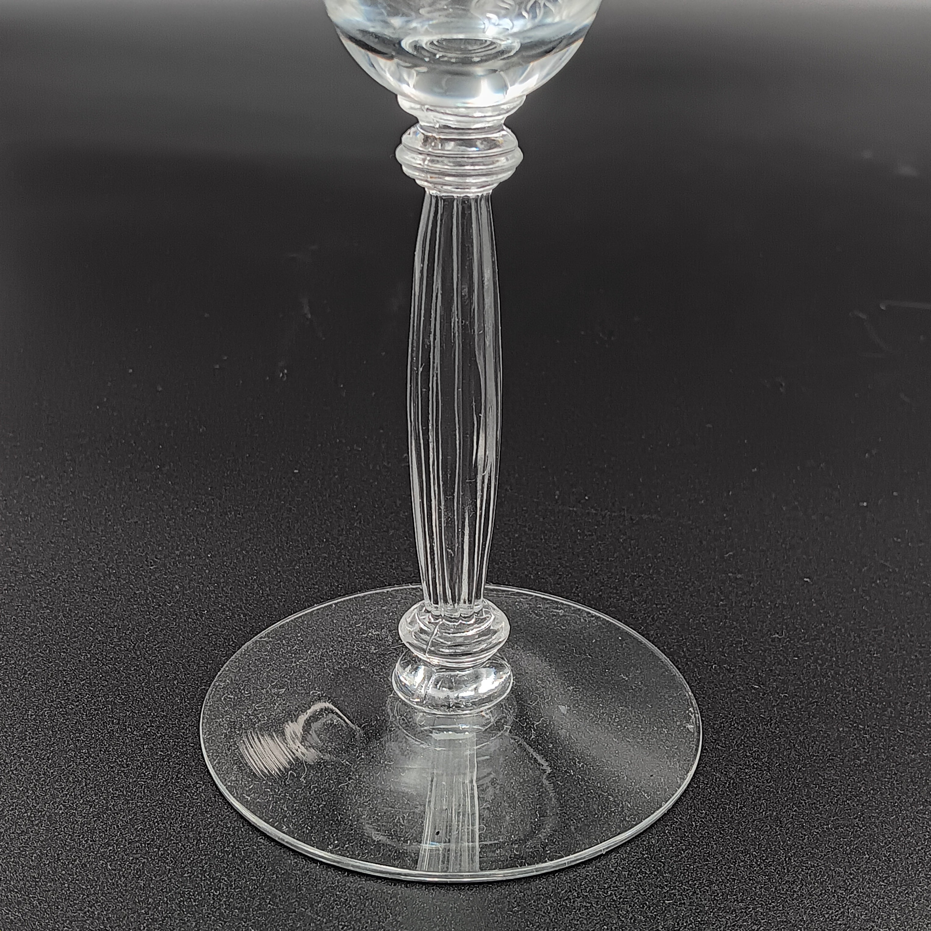 Vintage Tiffin-Franciscan 'Flanders Clear' 8¼ inch water goblet featuring intricate floral etching on the bowl, a ribbed stem, and a flat circular base.