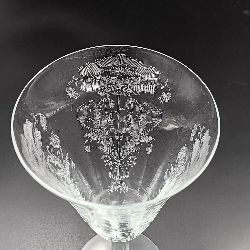 Vintage Tiffin-Franciscan 'Flanders Clear' 8¼ inch water goblet featuring intricate floral etching on the bowl, a ribbed stem, and a flat circular base.