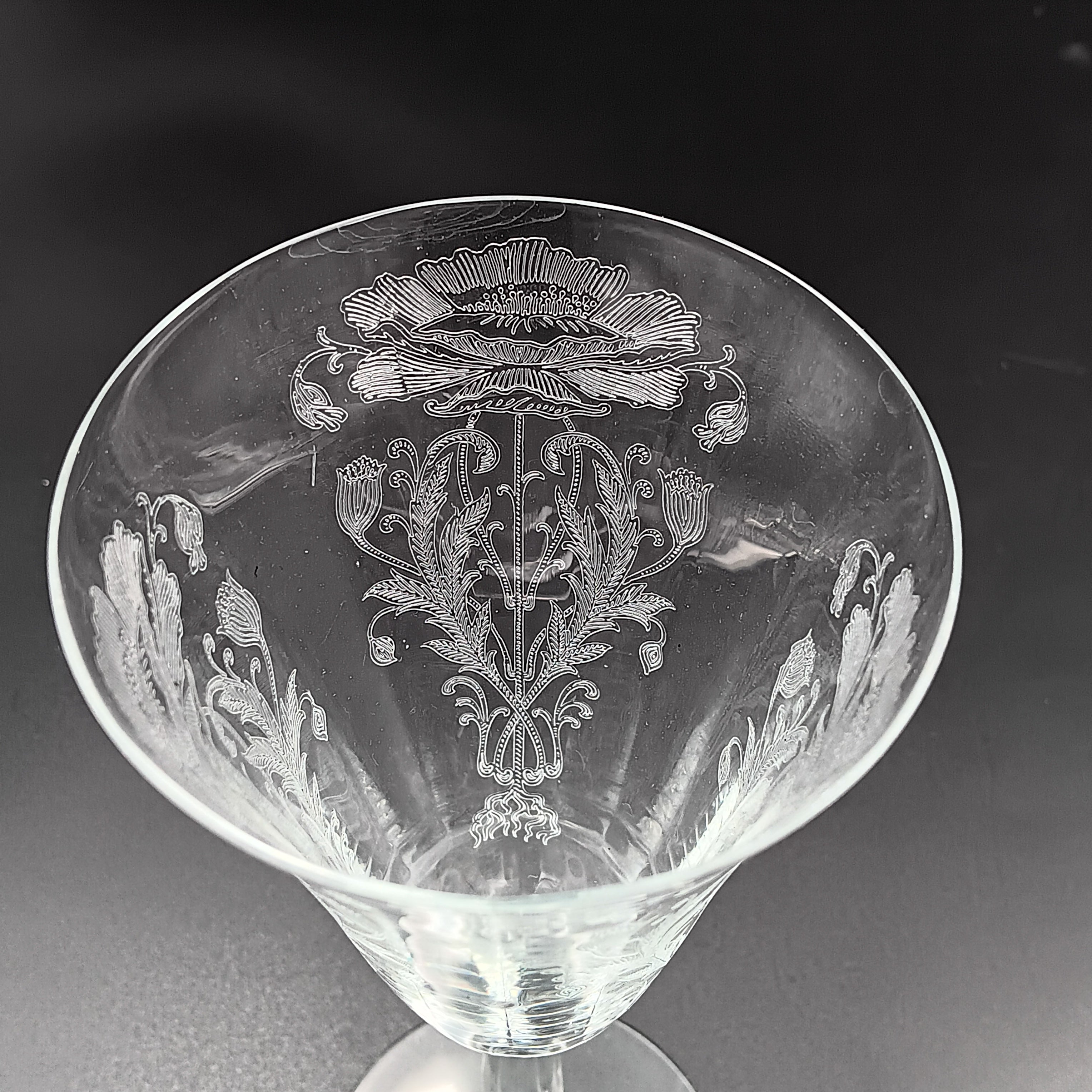 Vintage Tiffin-Franciscan 'Flanders Clear' 8¼ inch water goblet featuring intricate floral etching on the bowl, a ribbed stem, and a flat circular base.