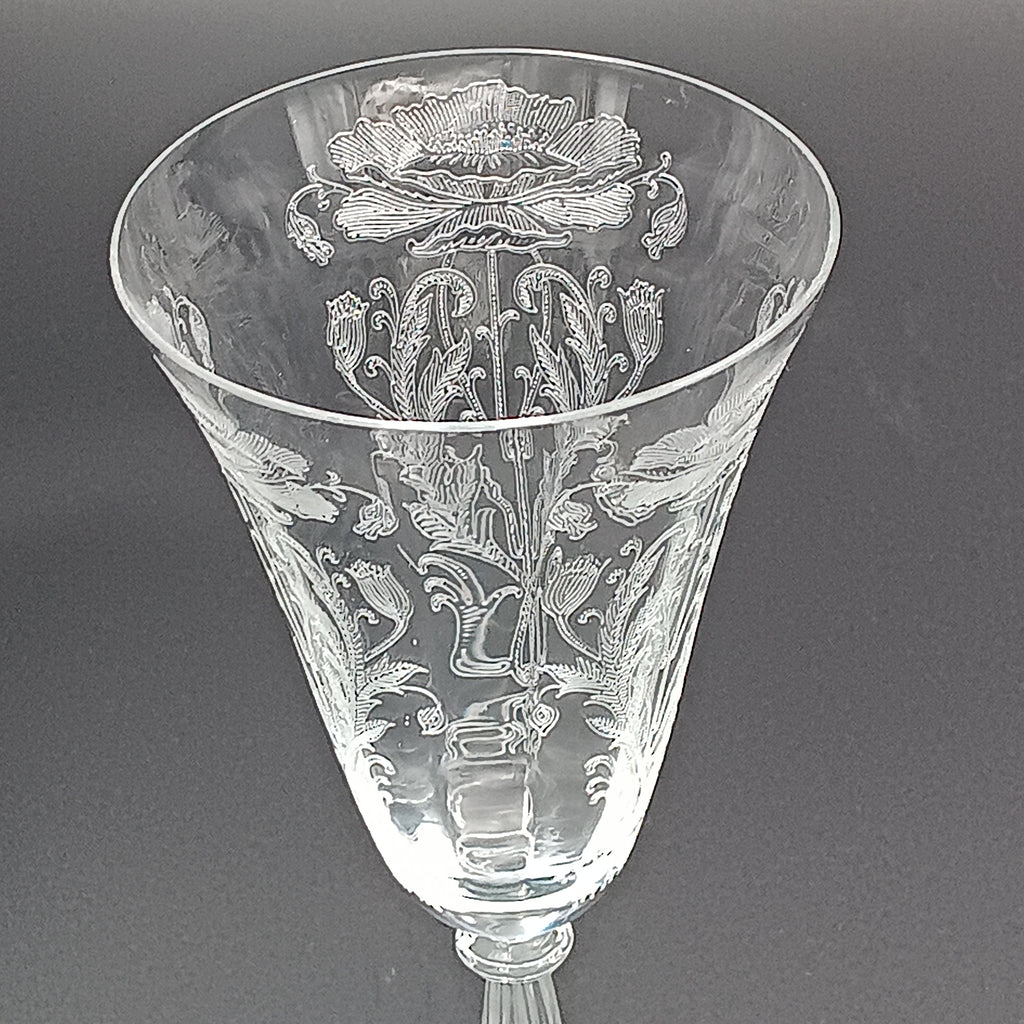 Vintage Tiffin-Franciscan 'Flanders Clear' 8¼ inch water goblet featuring intricate floral etching on the bowl, a ribbed stem, and a flat circular base.