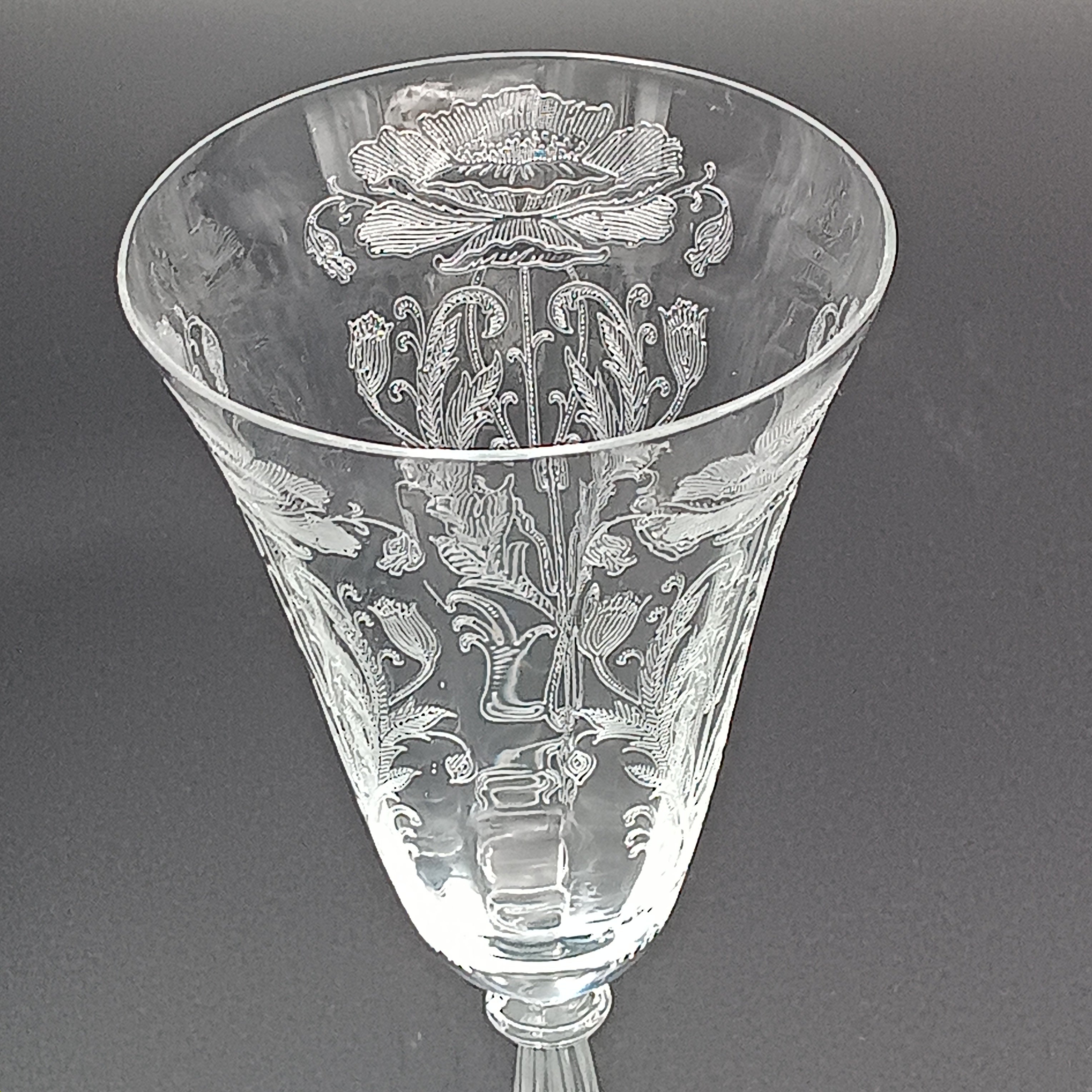 Vintage Tiffin-Franciscan 'Flanders Clear' 8¼ inch water goblet featuring intricate floral etching on the bowl, a ribbed stem, and a flat circular base.