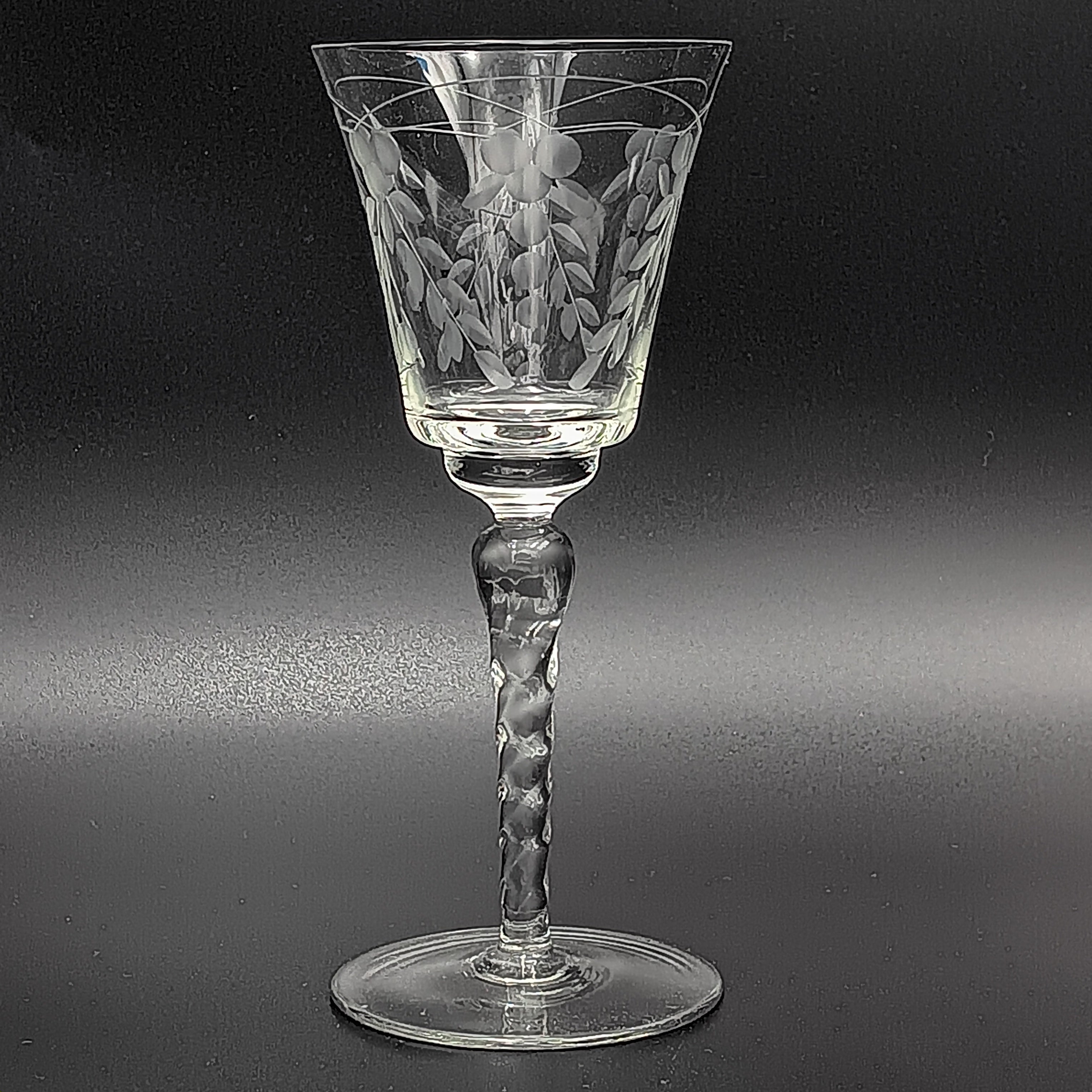A 6-inch cut crystal wine glass featuring etched leaf and berry patterns on the bowl, a twisted textured stem, and a flat base.