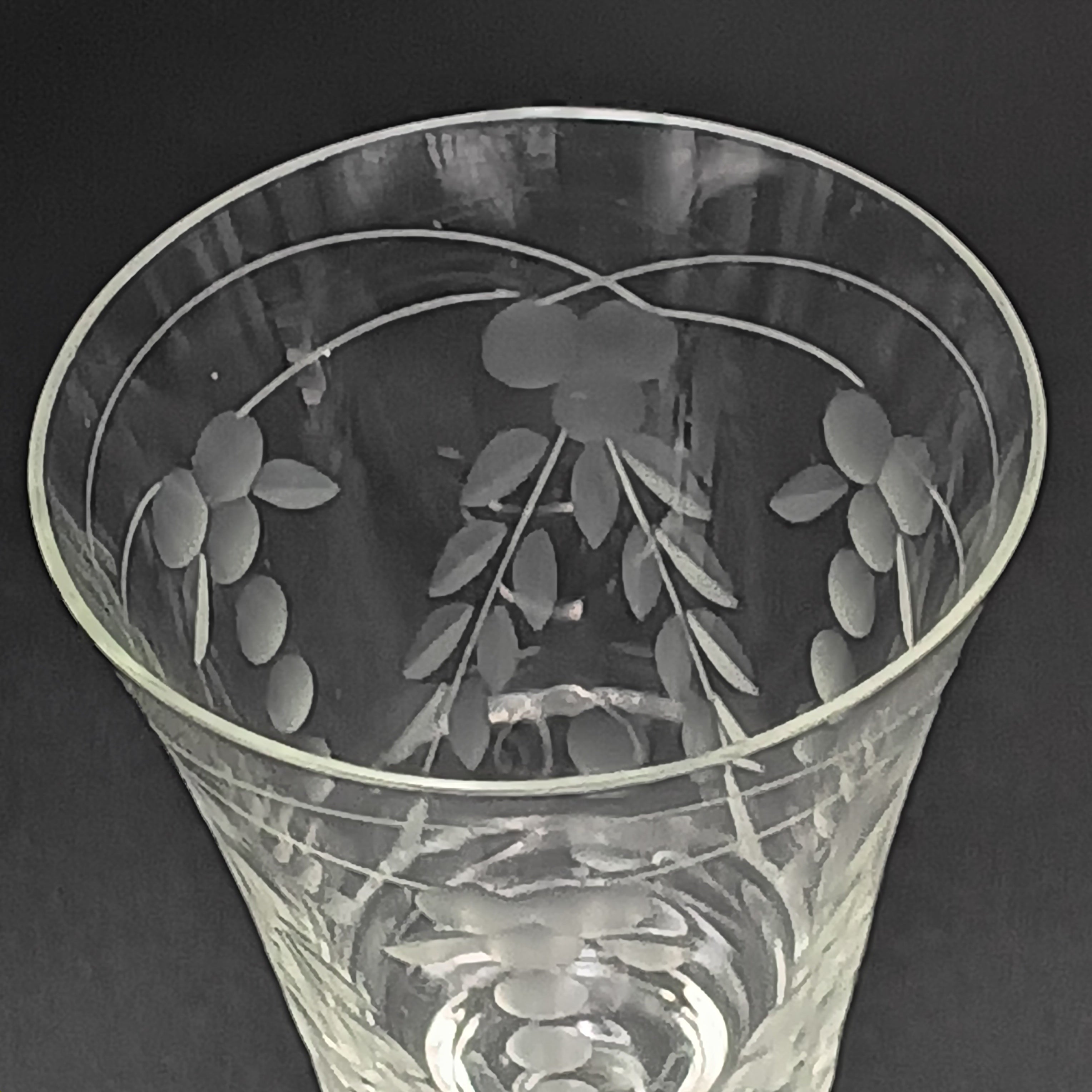 A 6-inch cut crystal wine glass featuring etched leaf and berry patterns on the bowl, a twisted textured stem, and a flat base.