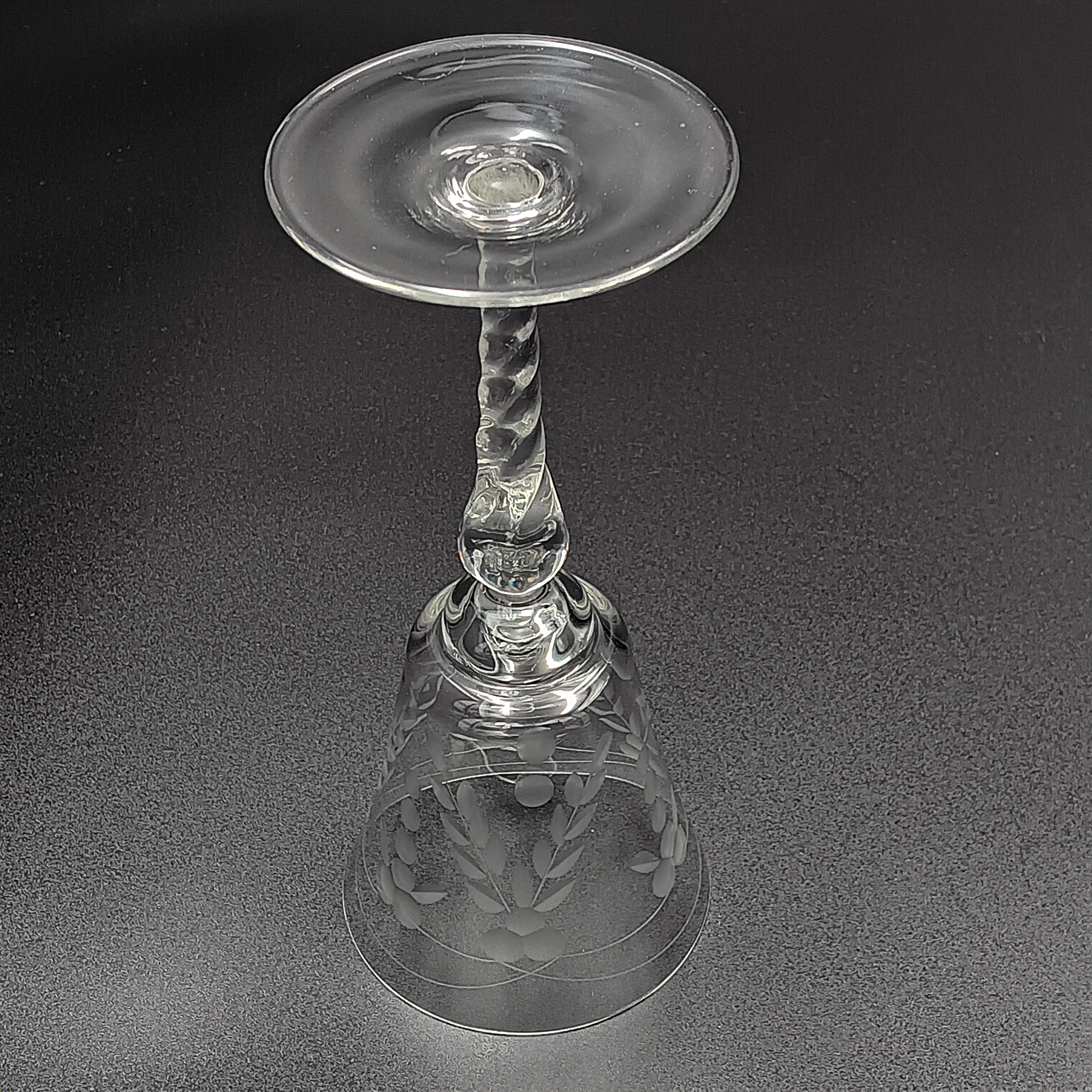 A 6-inch cut crystal wine glass featuring etched leaf and berry patterns on the bowl, a twisted textured stem, and a flat base.