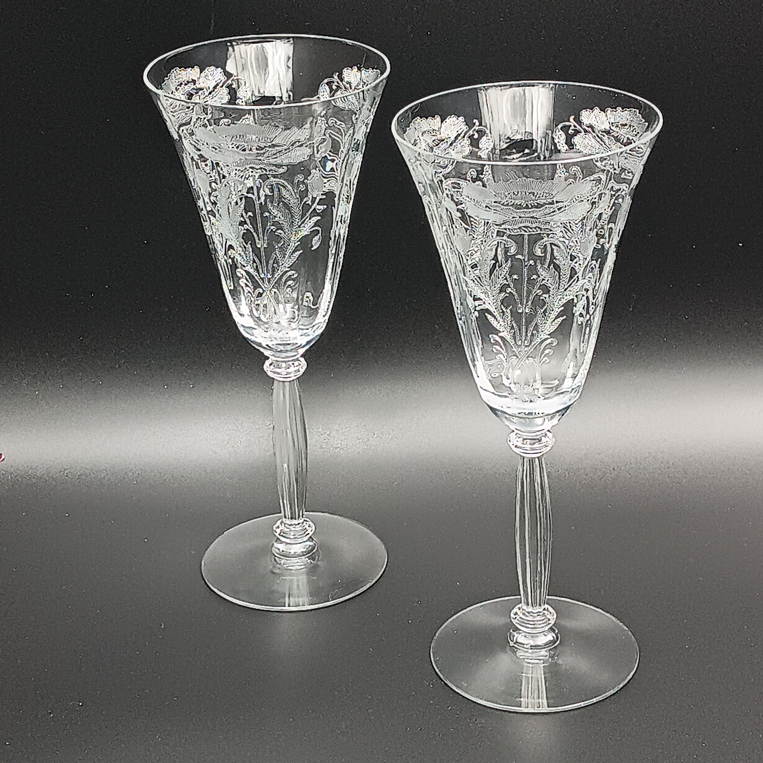 Vintage Tiffin-Franciscan 'Flanders Clear' 8¼ inch water goblet featuring intricate floral etching on the bowl, a ribbed stem, and a flat circular base.