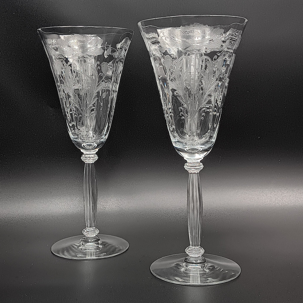 Vintage Tiffin-Franciscan 'Flanders Clear' 8¼ inch water goblet featuring intricate floral etching on the bowl, a ribbed stem, and a flat circular base.