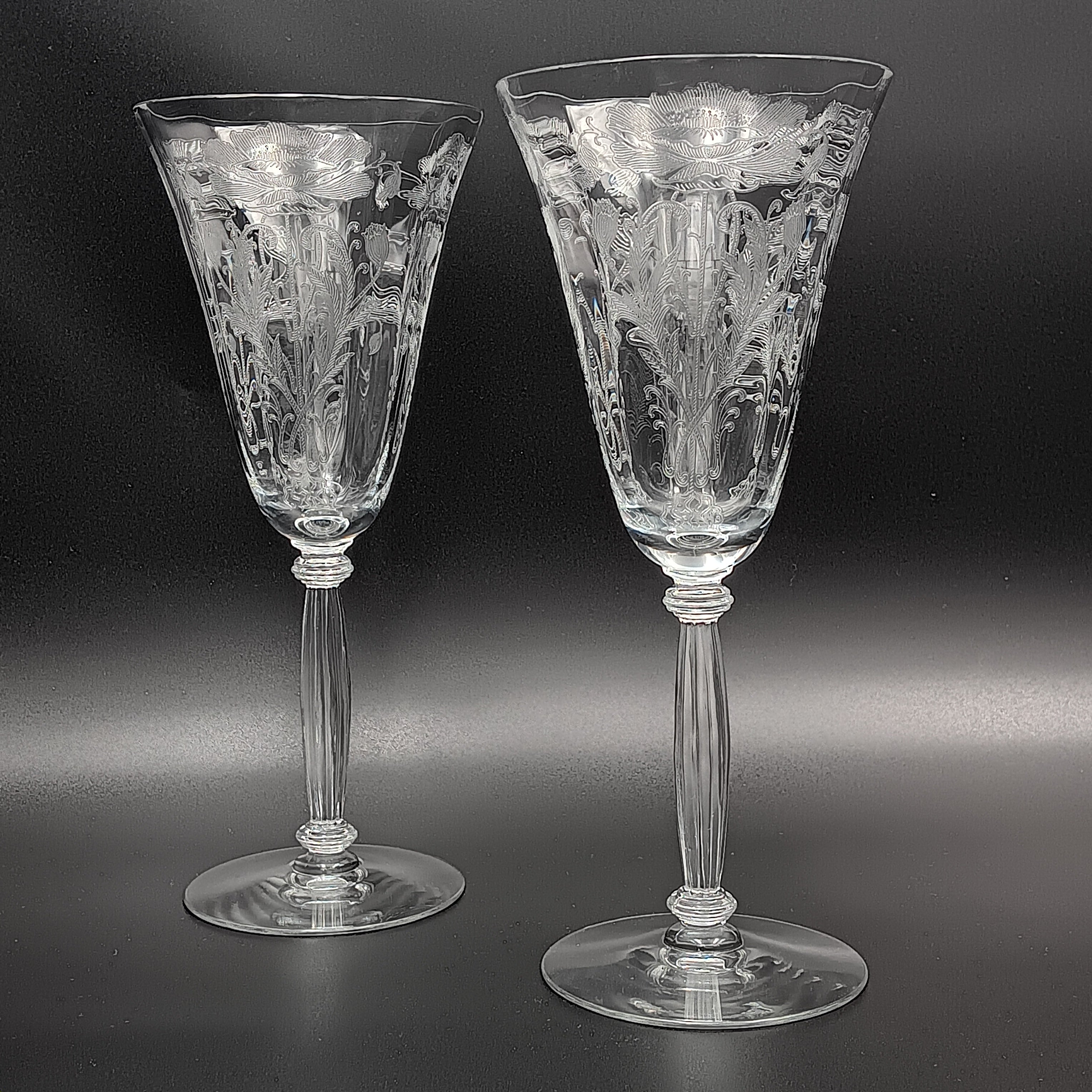 Vintage Tiffin-Franciscan 'Flanders Clear' 8¼ inch water goblet featuring intricate floral etching on the bowl, a ribbed stem, and a flat circular base.