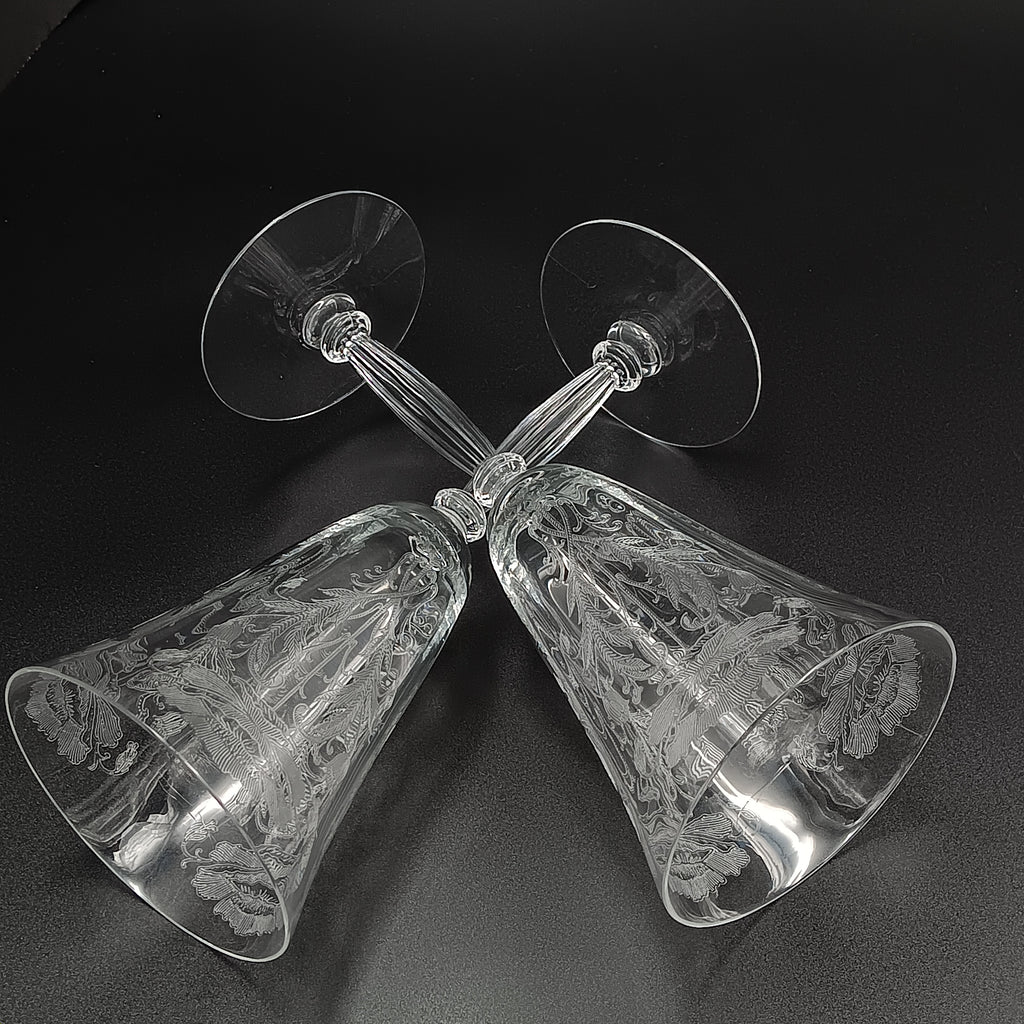 Vintage Tiffin-Franciscan 'Flanders Clear' 8¼ inch water goblet featuring intricate floral etching on the bowl, a ribbed stem, and a flat circular base.