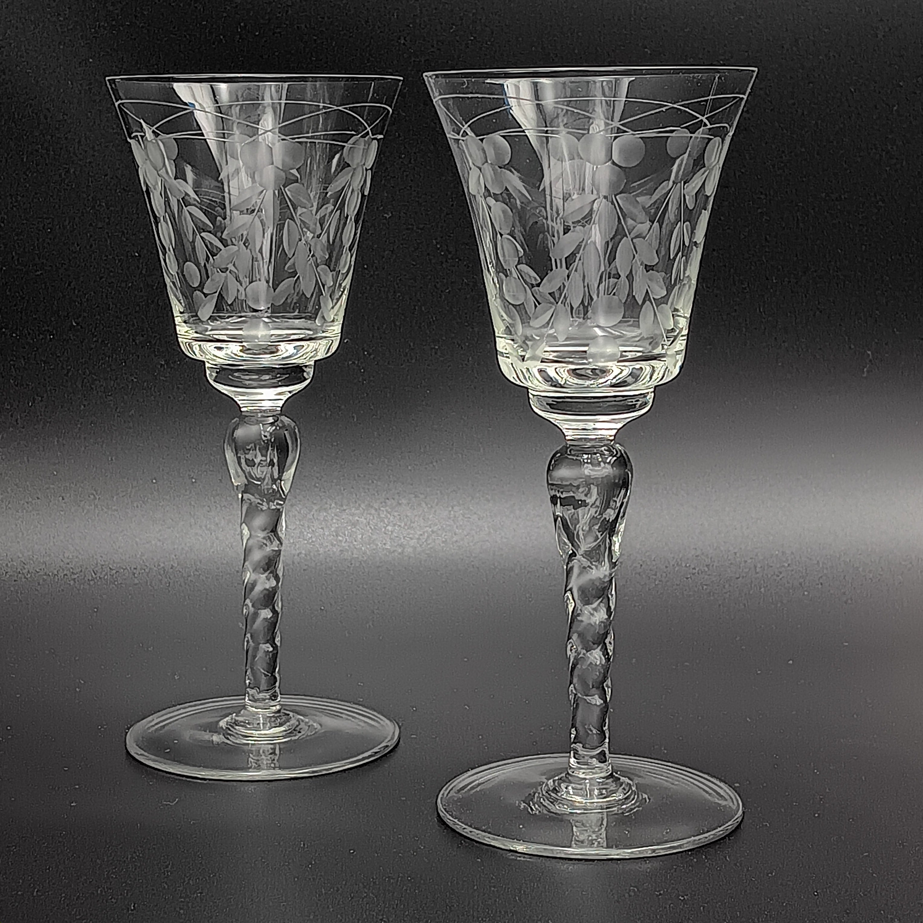 A 6-inch cut crystal wine glass featuring etched leaf and berry patterns on the bowl, a twisted textured stem, and a flat base.