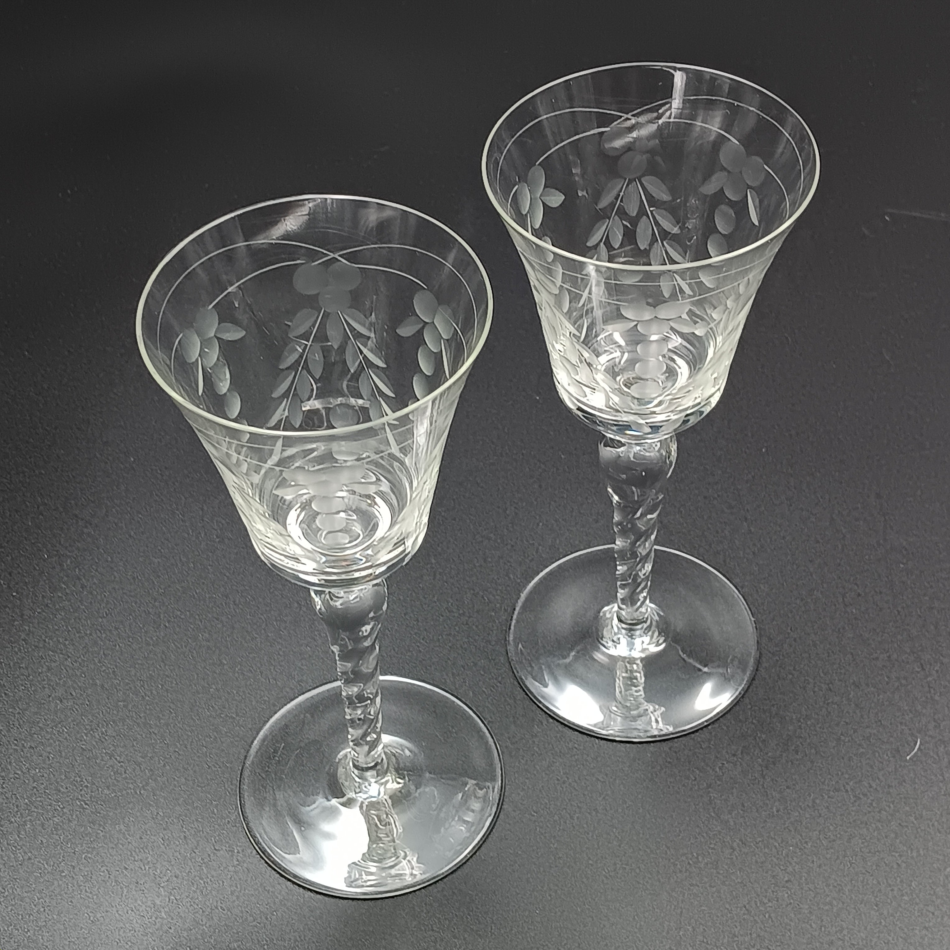 A 6-inch cut crystal wine glass featuring etched leaf and berry patterns on the bowl, a twisted textured stem, and a flat base.