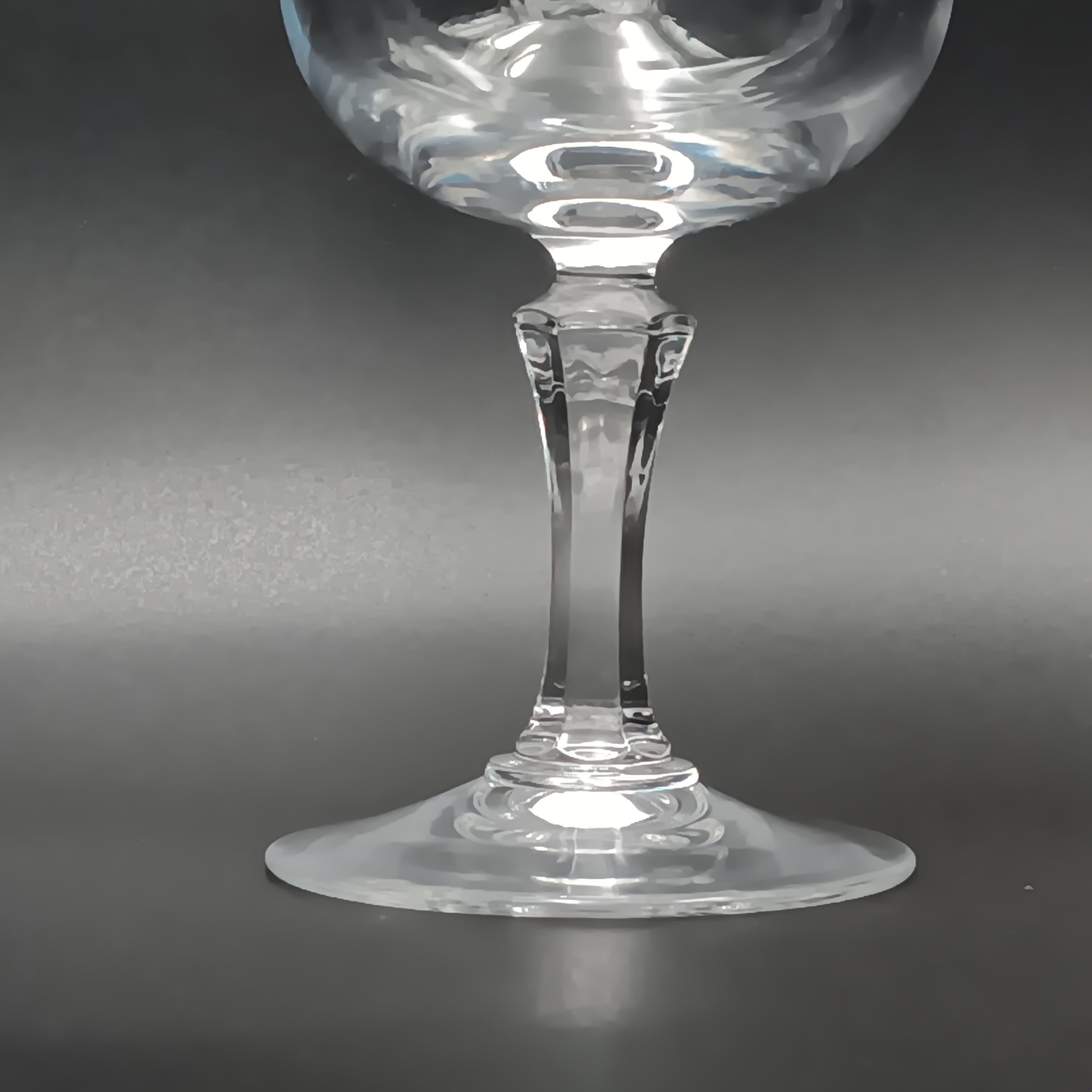 Clear crystal wine glass with etched floral and vine patterns.