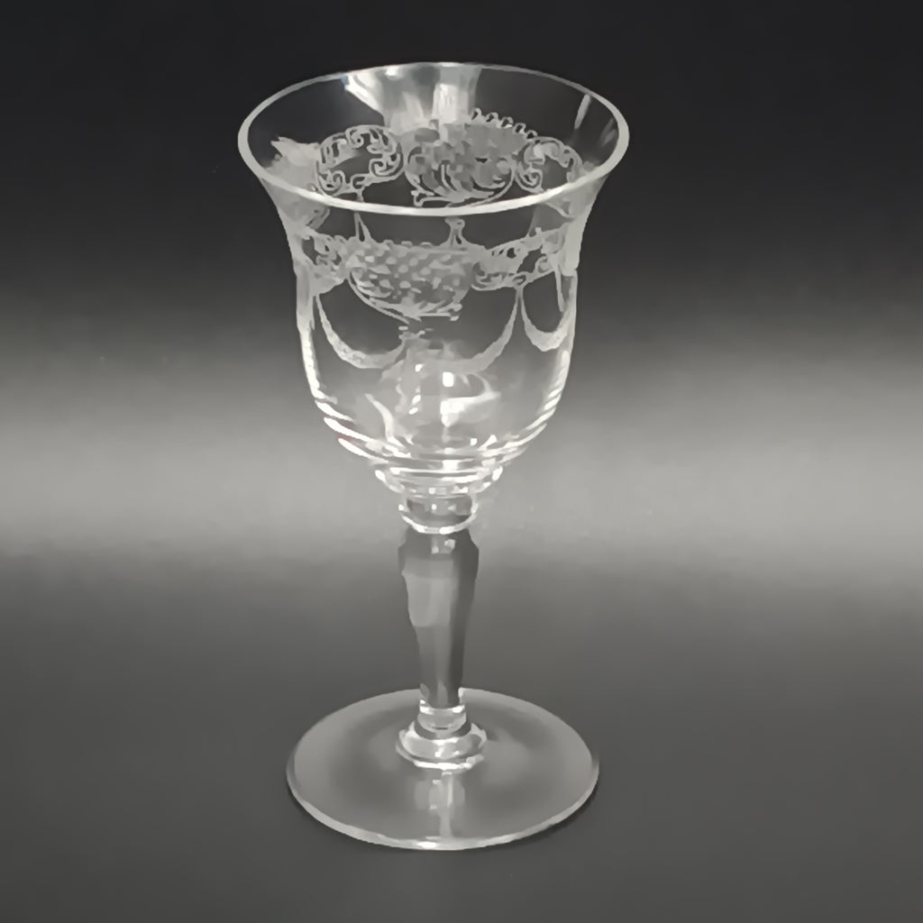 Clear 4½-inch etched crystal wine glass with ornate floral and crown-like patterns on the bowl, faceted stem, and wide flat base