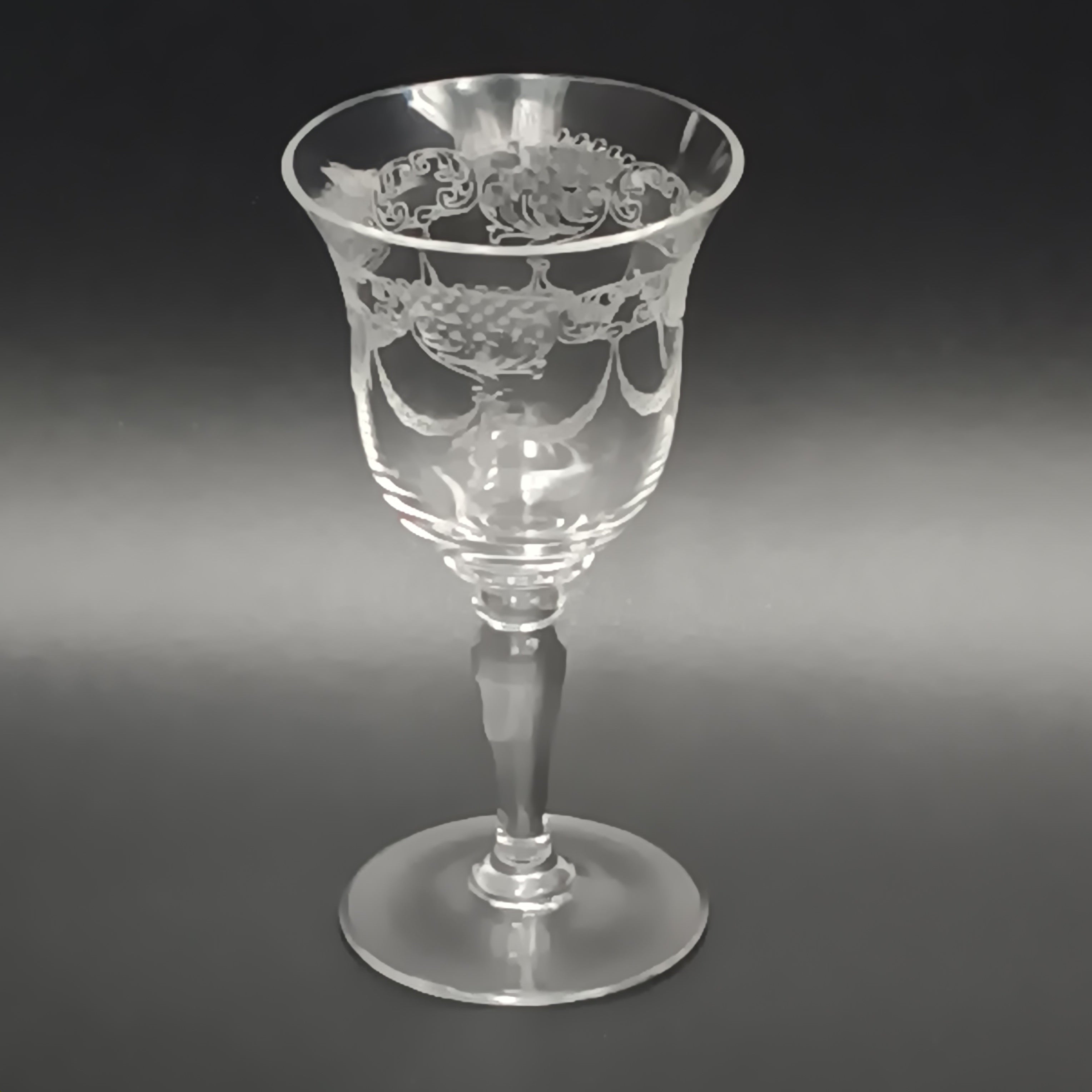 Clear 4½-inch etched crystal wine glass with ornate floral and crown-like patterns on the bowl, faceted stem, and wide flat base