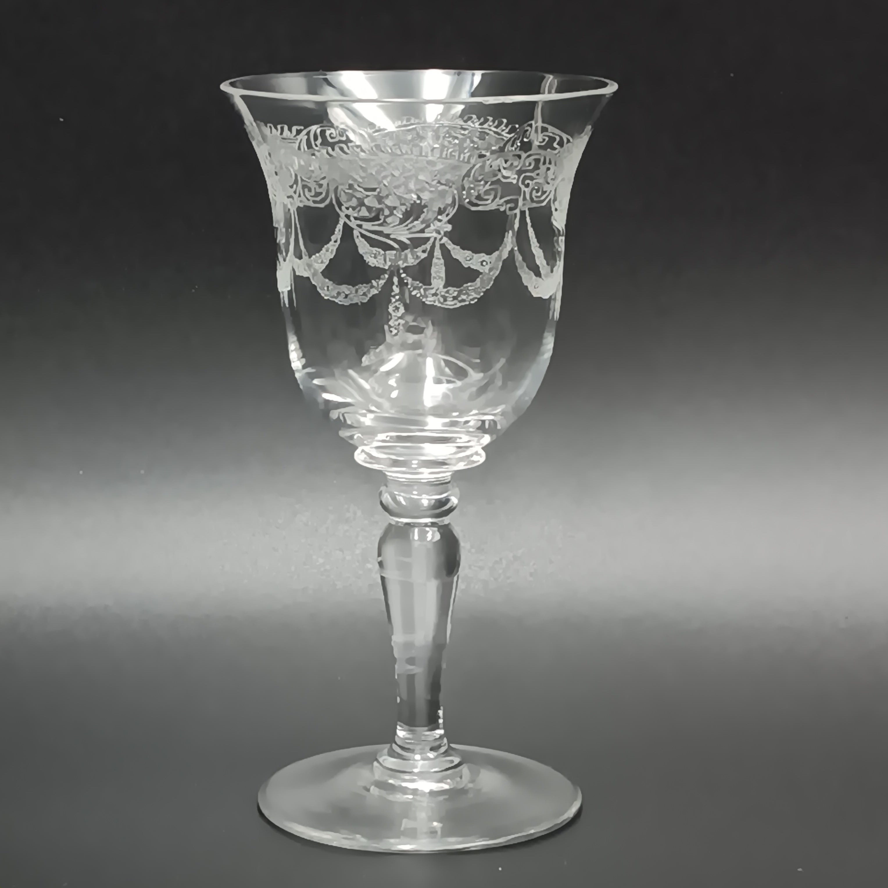 Clear 4½-inch etched crystal wine glass with ornate floral and crown-like patterns on the bowl, faceted stem, and wide flat base