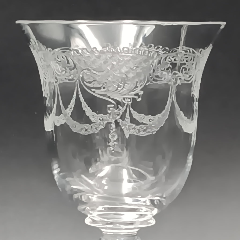 Clear 4½-inch etched crystal wine glass with ornate floral and crown-like patterns on the bowl, faceted stem, and wide flat base