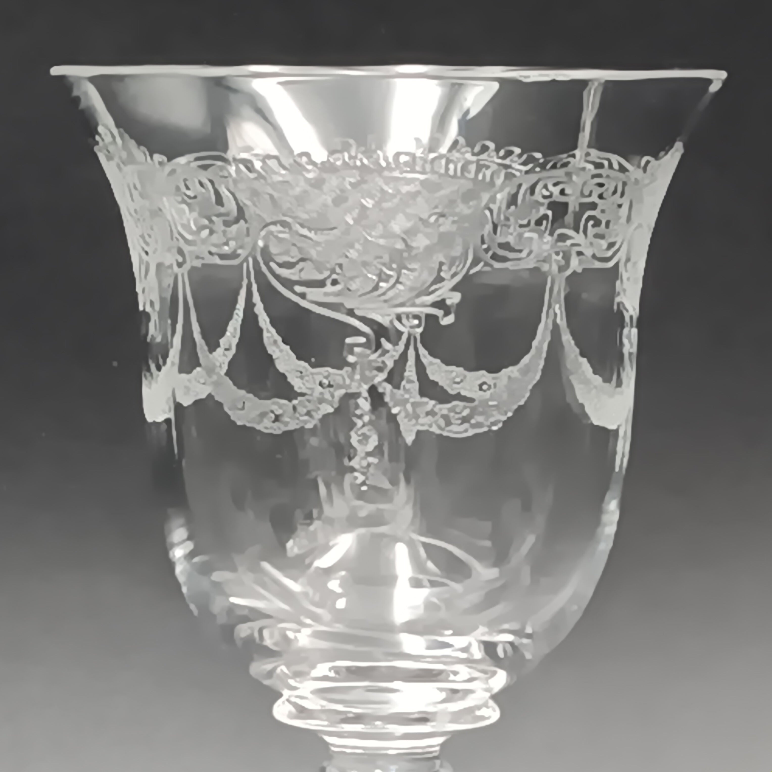 Clear 4½-inch etched crystal wine glass with ornate floral and crown-like patterns on the bowl, faceted stem, and wide flat base
