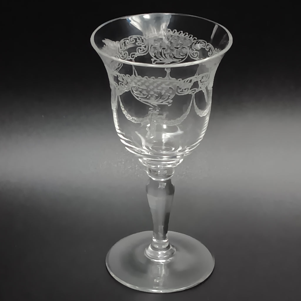 Clear 4½-inch etched crystal wine glass with ornate floral and crown-like patterns on the bowl, faceted stem, and wide flat base