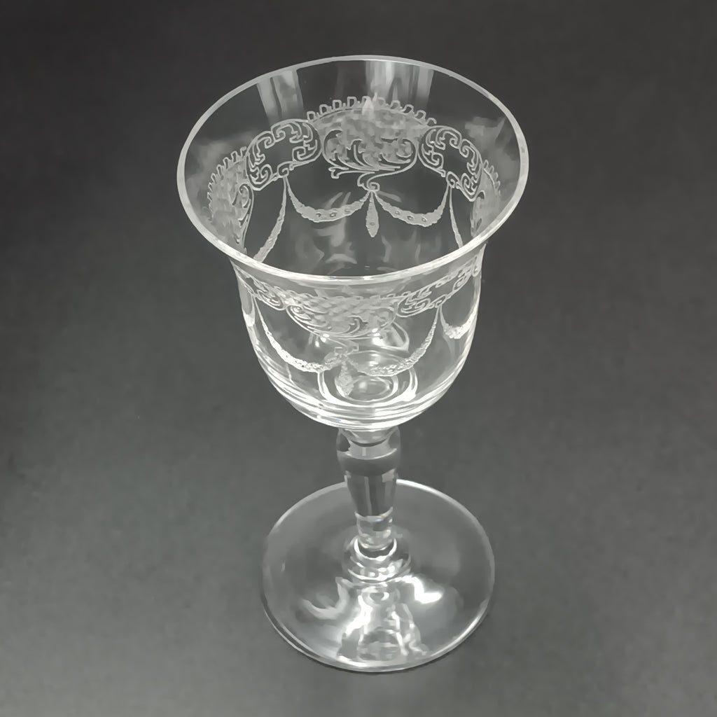 Clear 4½-inch etched crystal wine glass with ornate floral and crown-like patterns on the bowl, faceted stem, and wide flat base