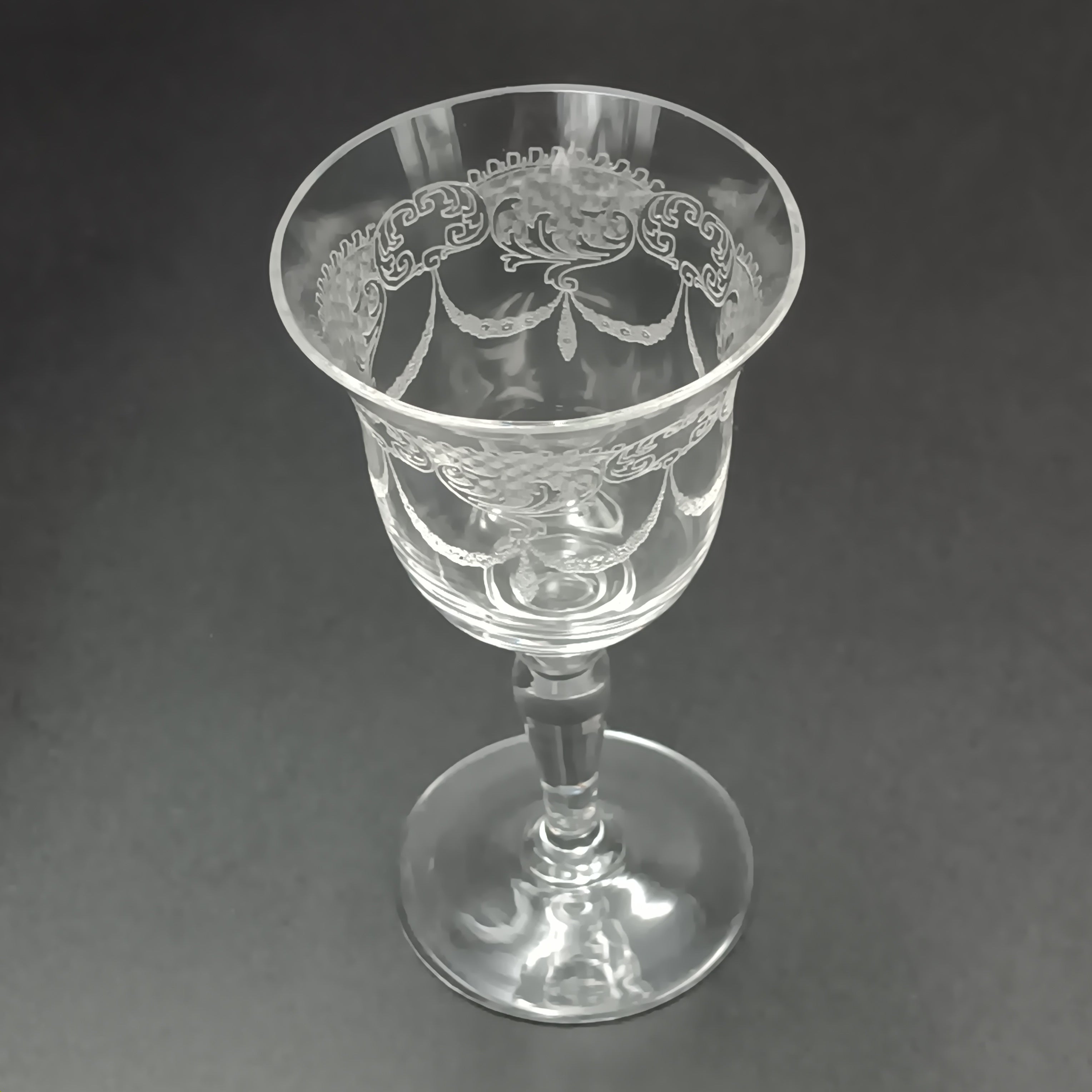 Clear 4½-inch etched crystal wine glass with ornate floral and crown-like patterns on the bowl, faceted stem, and wide flat base