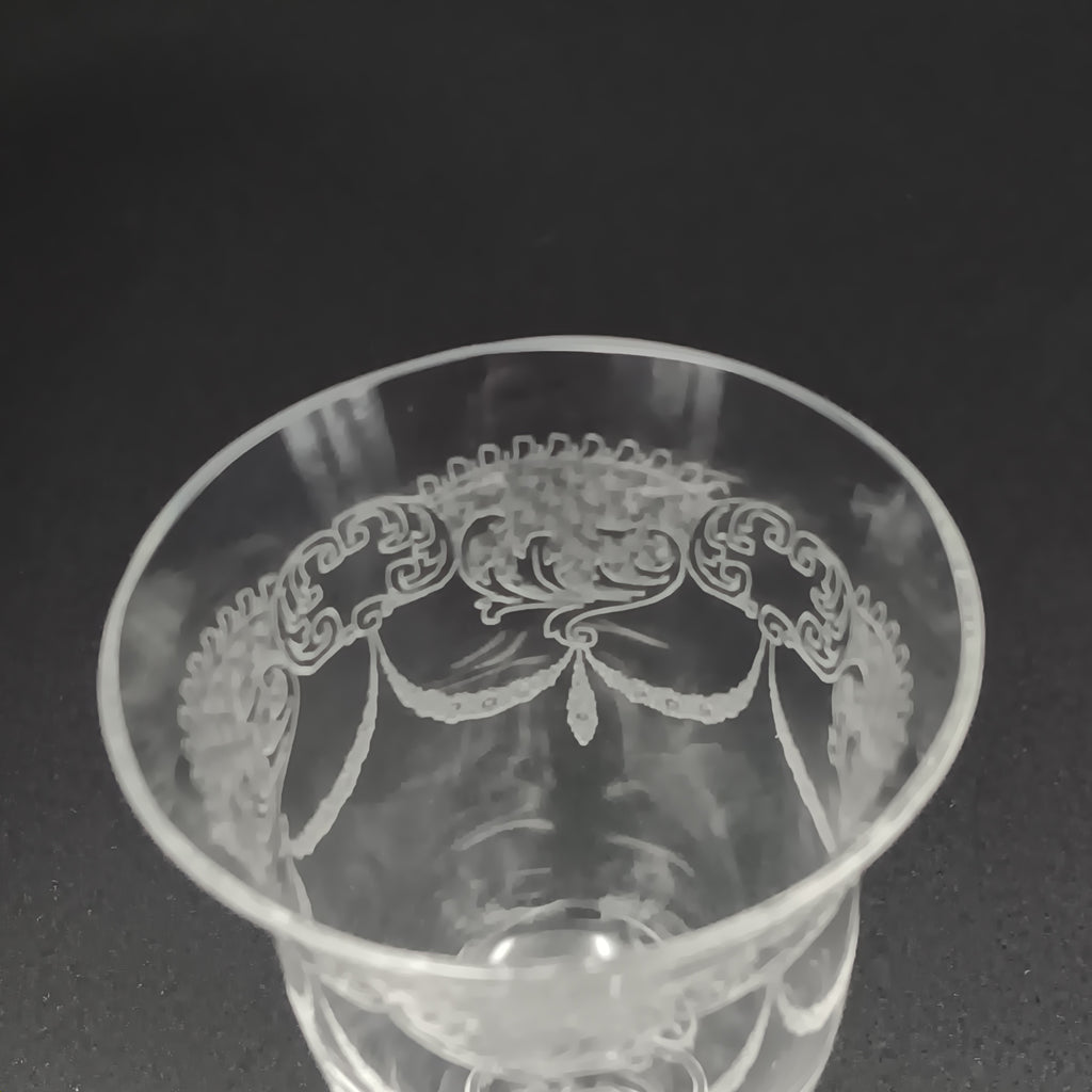 Clear 4½-inch etched crystal wine glass with ornate floral and crown-like patterns on the bowl, faceted stem, and wide flat base