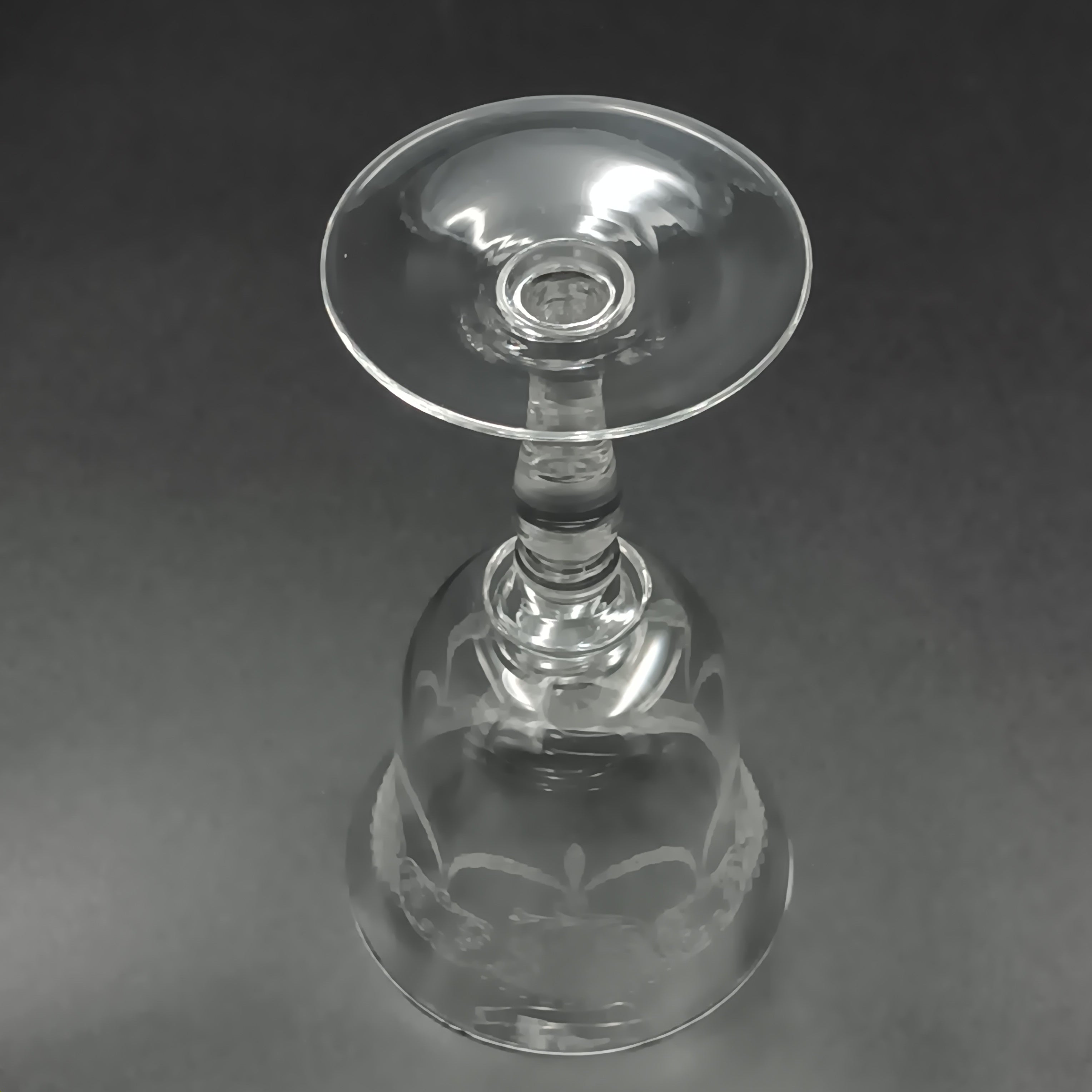 Clear 4½-inch etched crystal wine glass with ornate floral and crown-like patterns on the bowl, faceted stem, and wide flat base