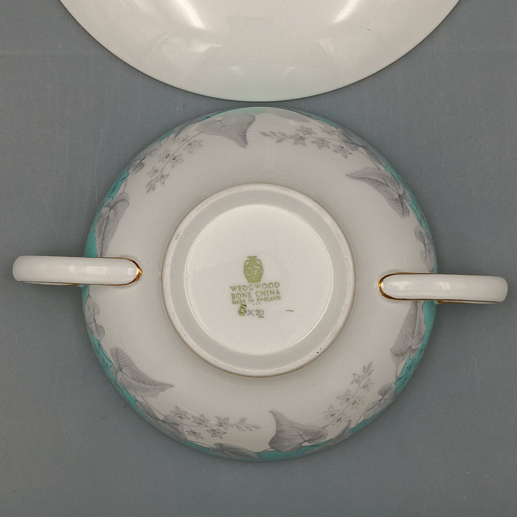 Wedgwood 'Buxton' double-handled soup bowl and saucer set featuring a turquoise background with gray and white floral design, accented by gold trim on edges; elegant English porcelain tableware ideal for collectors.