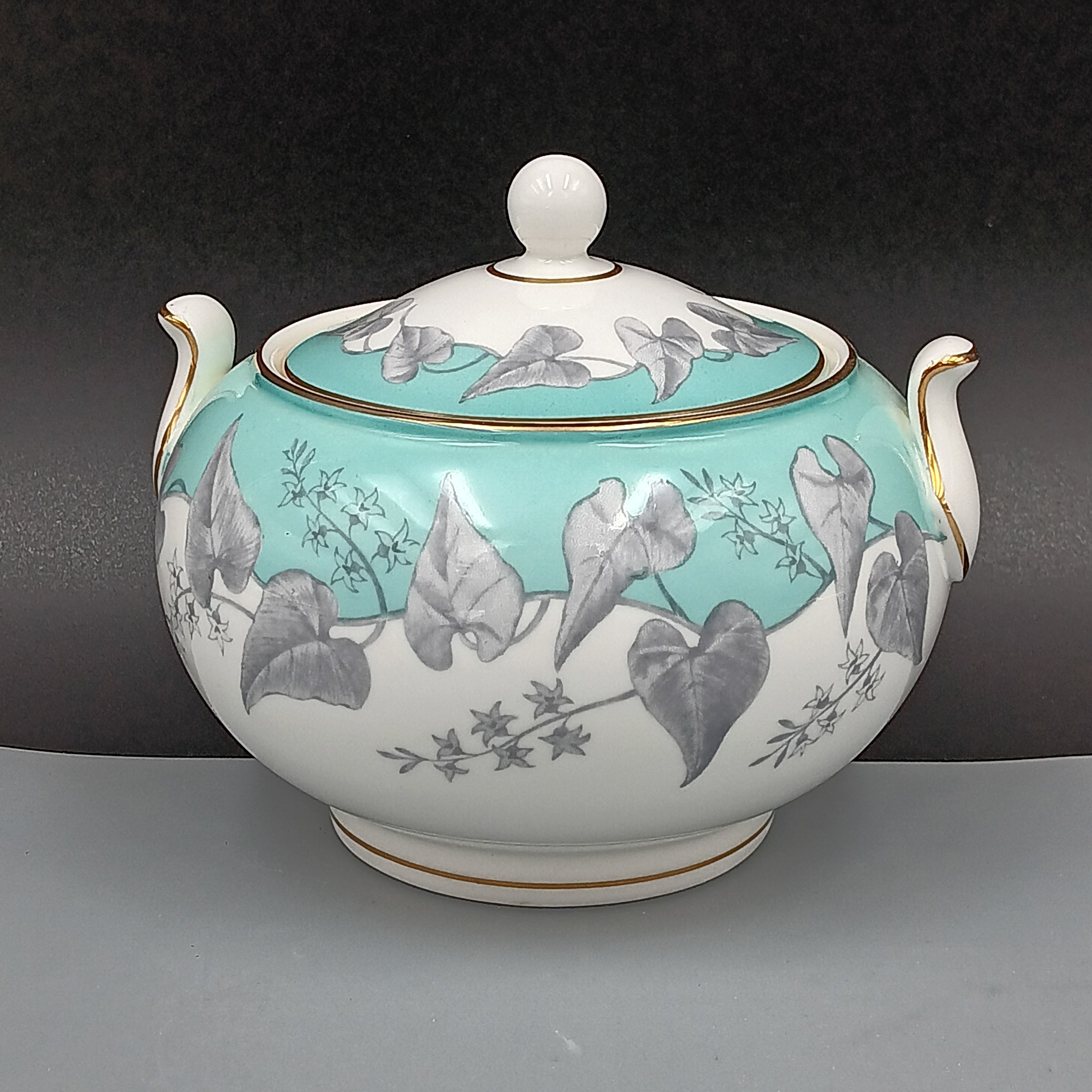 Sugar dish with floral design on a gray background