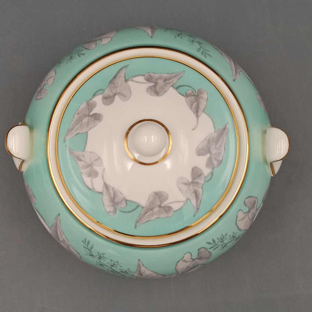Vintage Wedgwood ‘Buxton Turquoise’ lidded sugar dish with white porcelain body, turquoise band, gray floral motif, and gold-trimmed handles and lid.