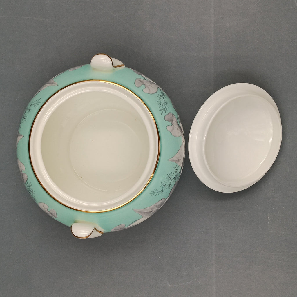Vintage Wedgwood ‘Buxton Turquoise’ lidded sugar dish with white porcelain body, turquoise band, gray floral motif, and gold-trimmed handles and lid.