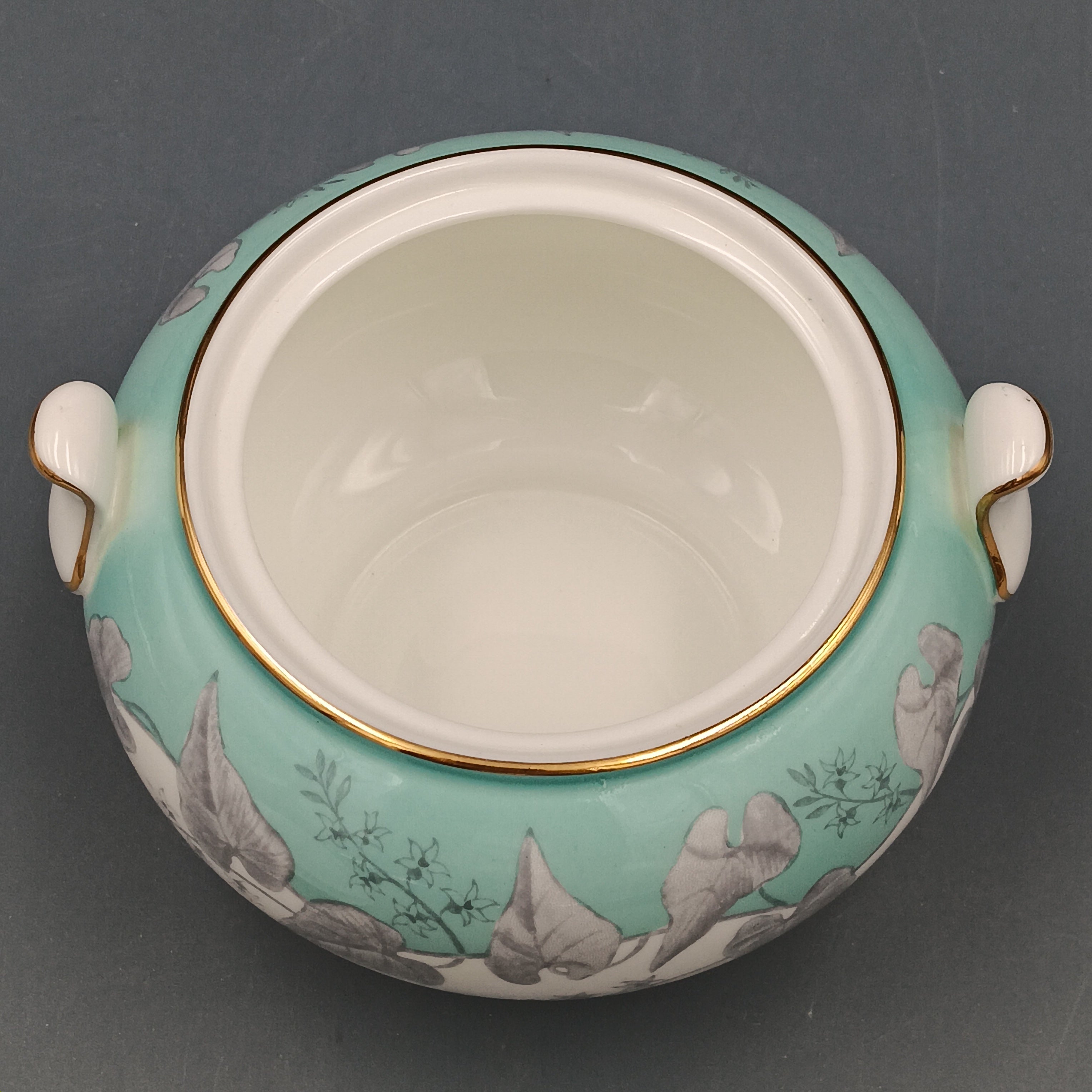Vintage Wedgwood ‘Buxton Turquoise’ lidded sugar dish with white porcelain body, turquoise band, gray floral motif, and gold-trimmed handles and lid.