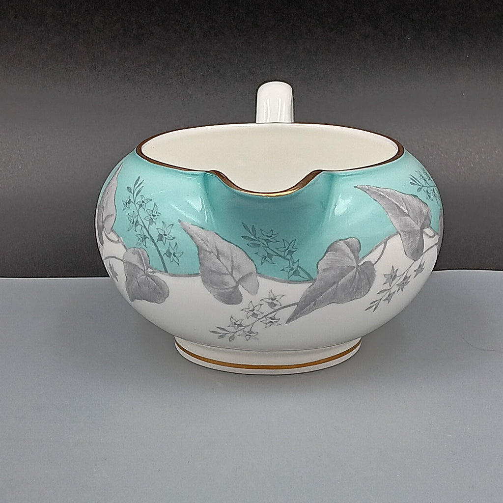 Wedgwood Buxton Turquoise creamer with gold trim, featuring a turquoise band and gray botanical motif on white porcelain