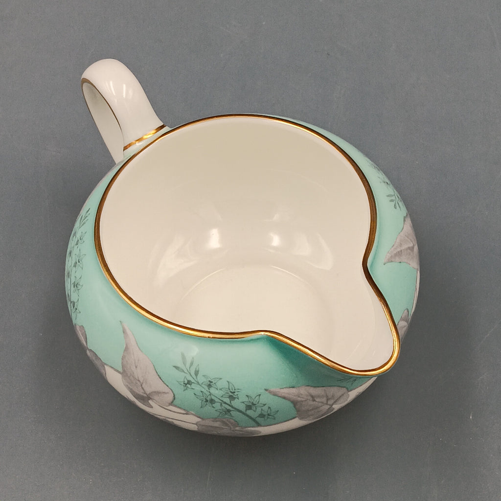Wedgwood Buxton Turquoise creamer with gold trim, featuring a turquoise band and gray botanical motif on white porcelain