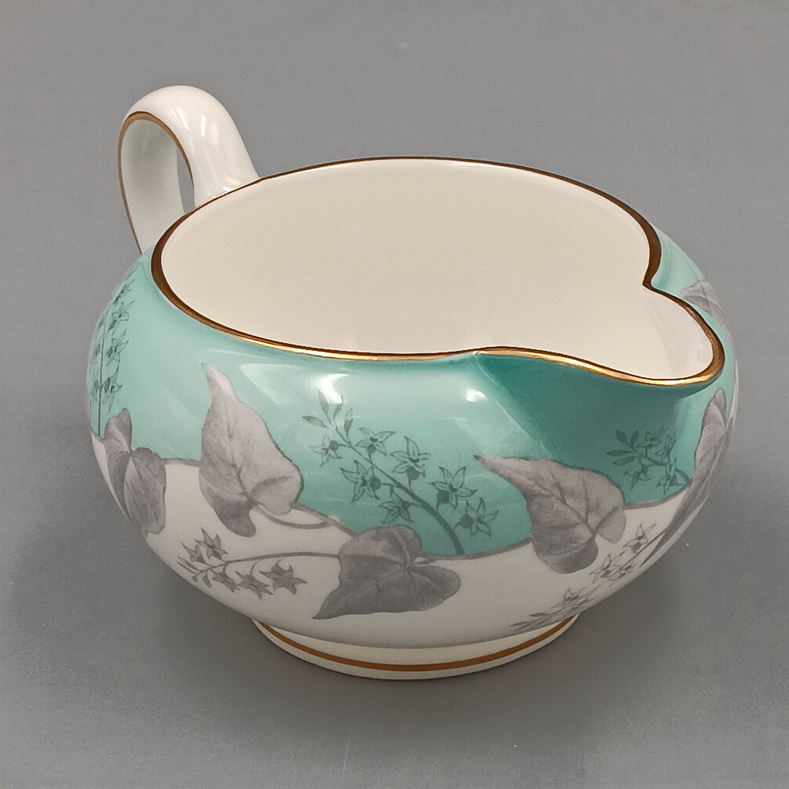 Wedgwood Buxton Turquoise creamer with gold trim, featuring a turquoise band and gray botanical motif on white porcelain