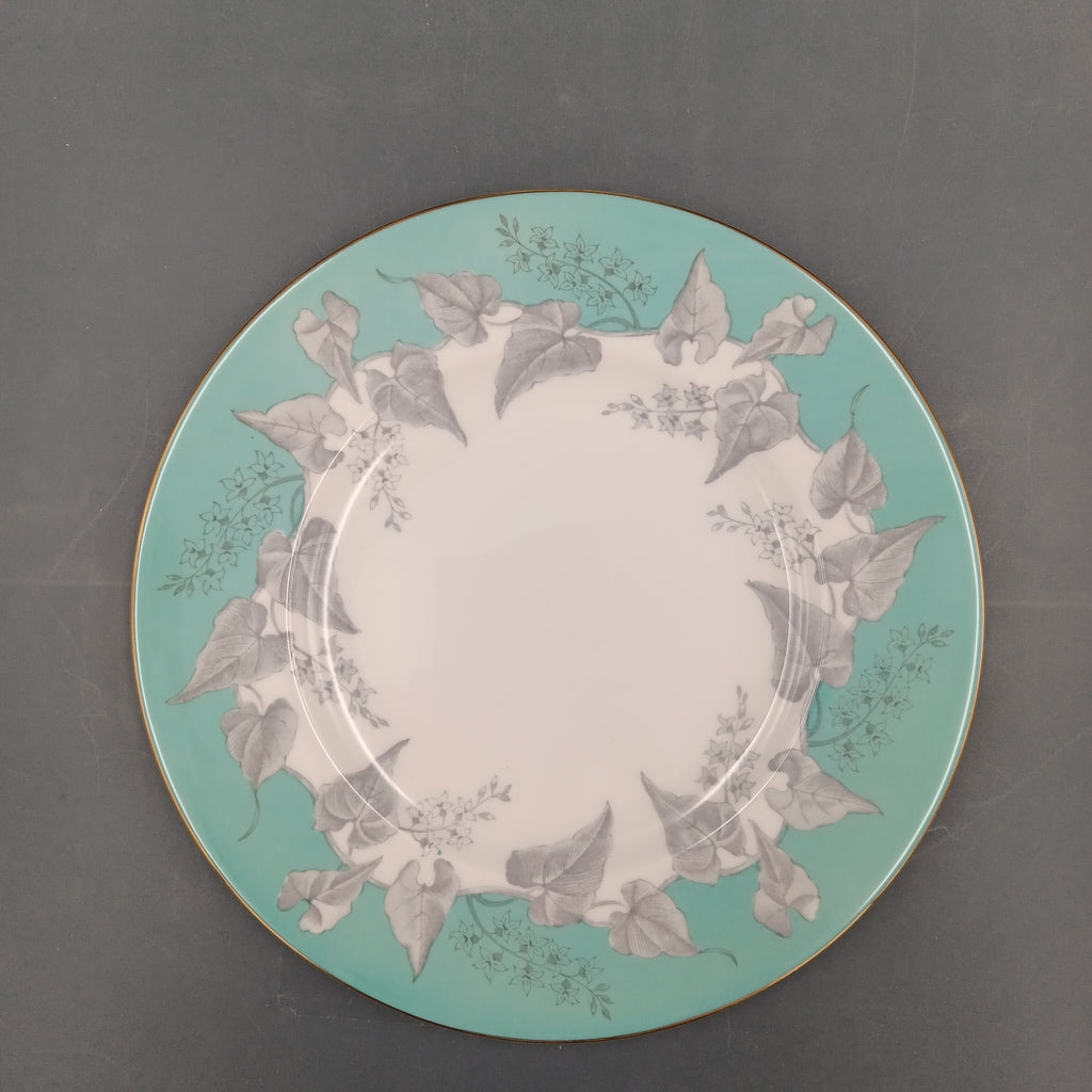 Decorative plate with floral design on a teal background