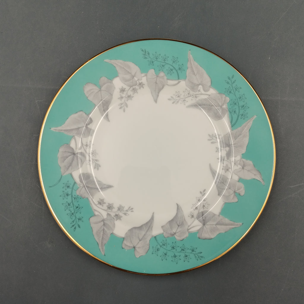 Decorative plate with floral design on a teal background