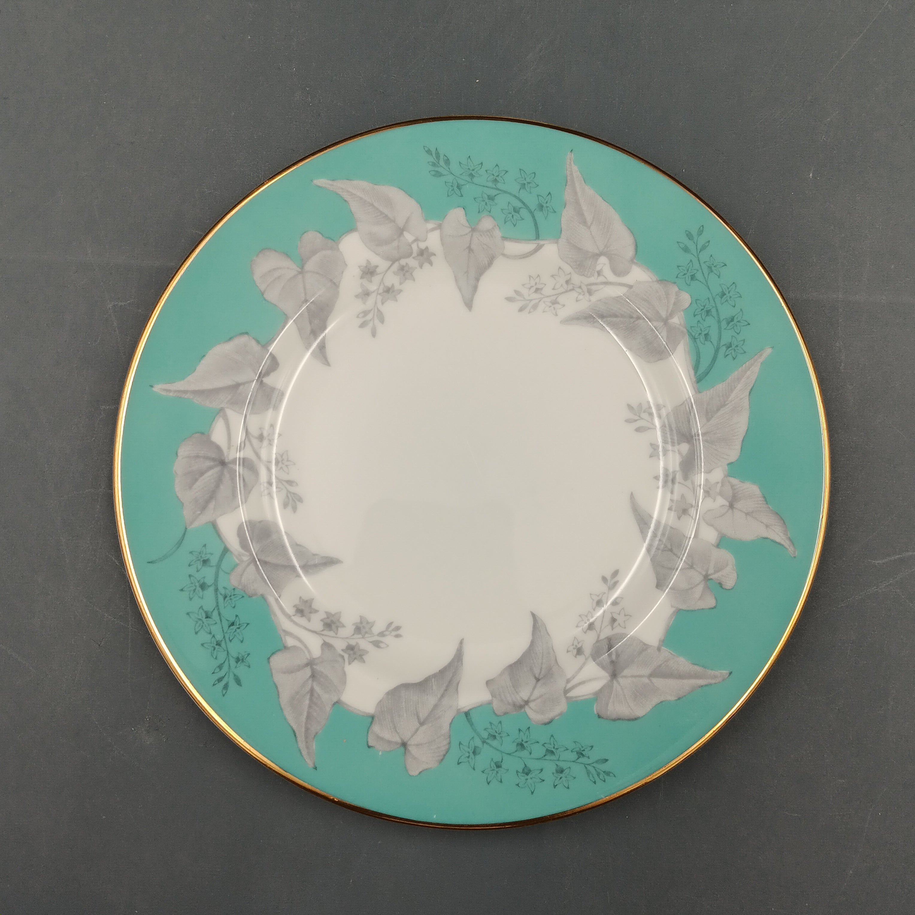 Decorative plate with floral design on a teal background