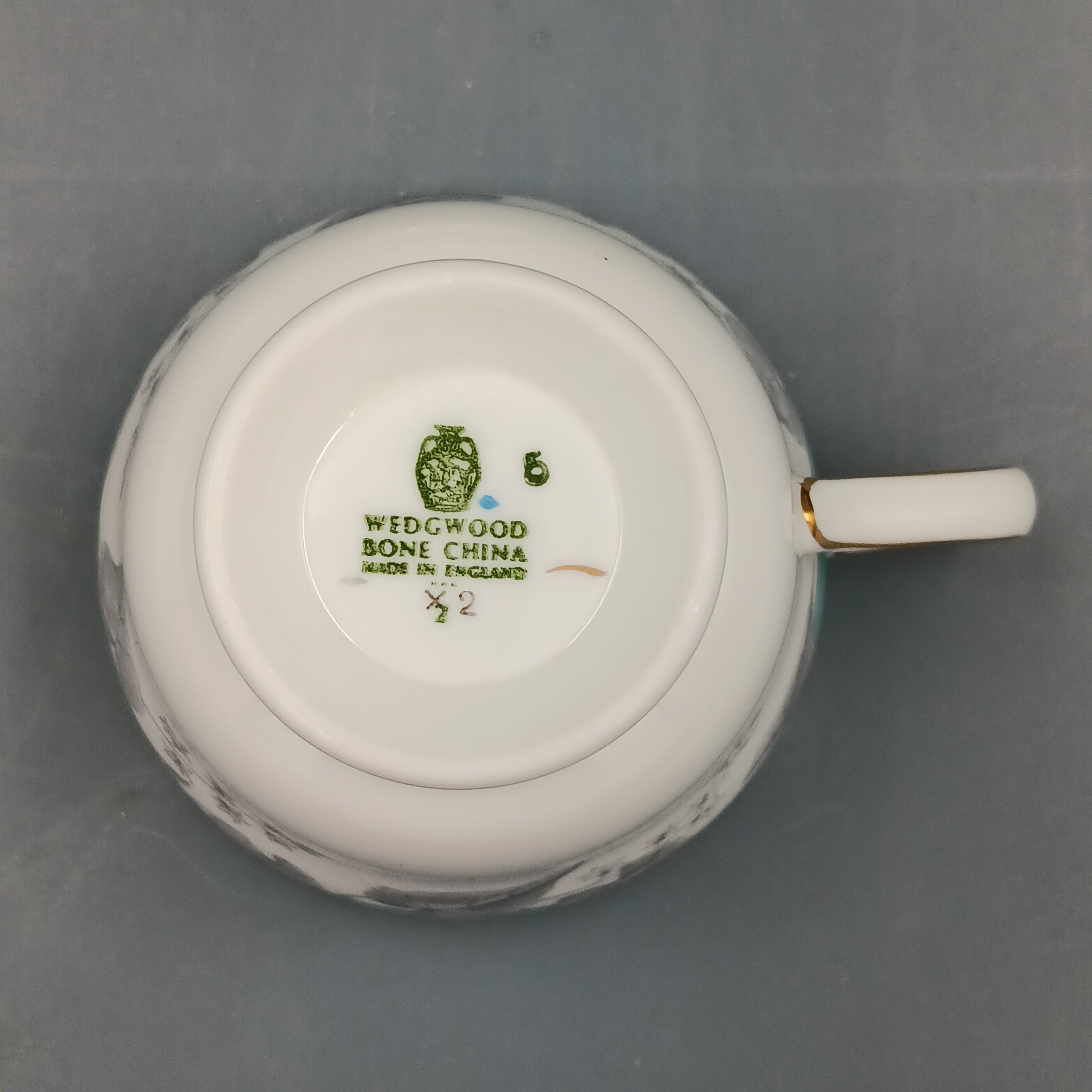 Wedgwood china cup with visible brand logo on a gray background